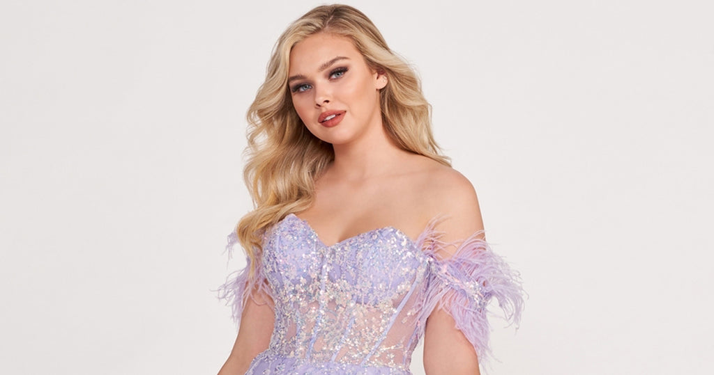 Prom goer wearing a prom dress with off-shoulder feather straps.