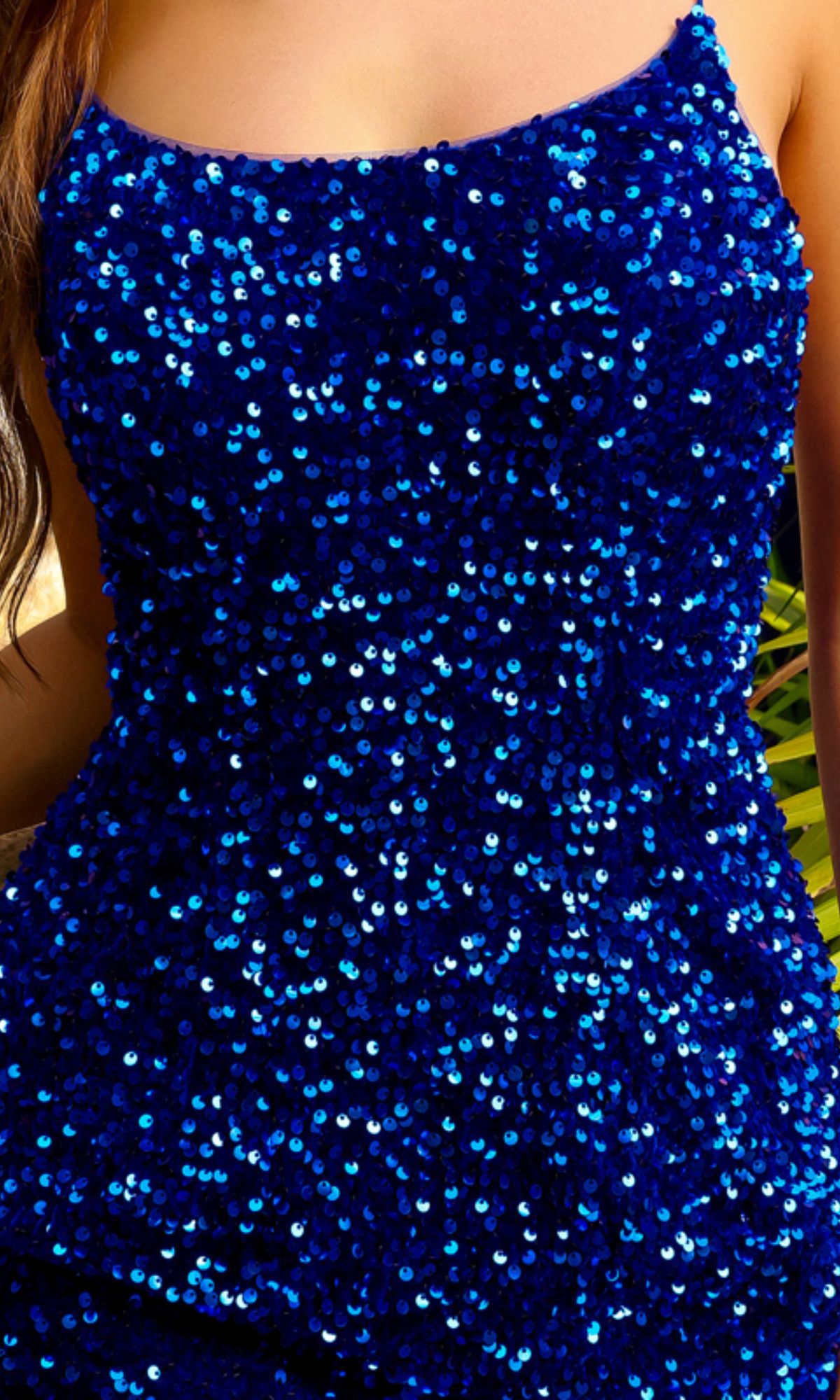 Close-up of a person wearing the Velvet Sequin Mini Homecoming Dress BZ024S, a sleeveless, form-fitting mini dress featuring an open back and shiny blue sequin details.