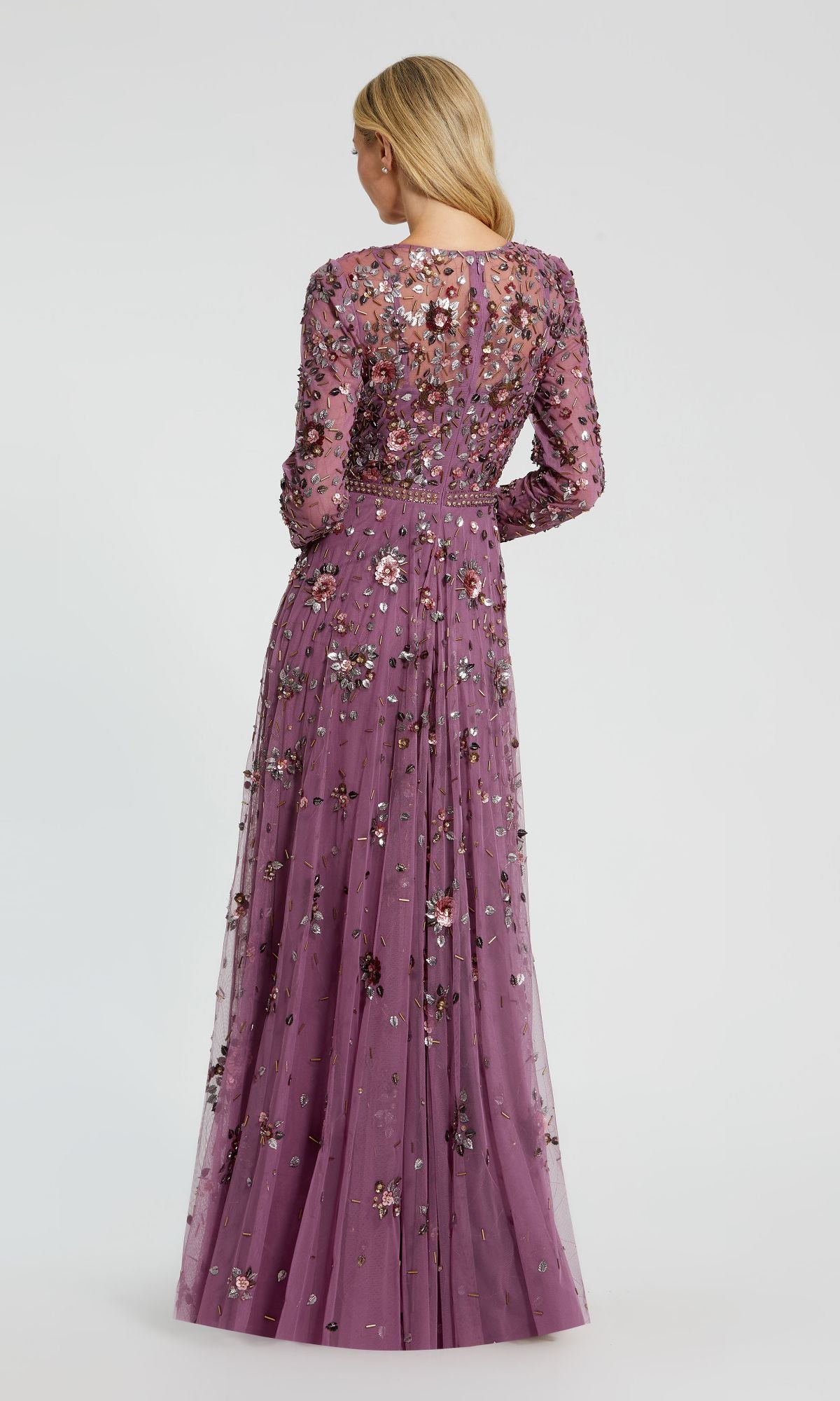 A woman with long blonde hair wears the Mac Duggal 10063 Long Sleeve Beaded Formal Dress, shown from the back against a plain light background.