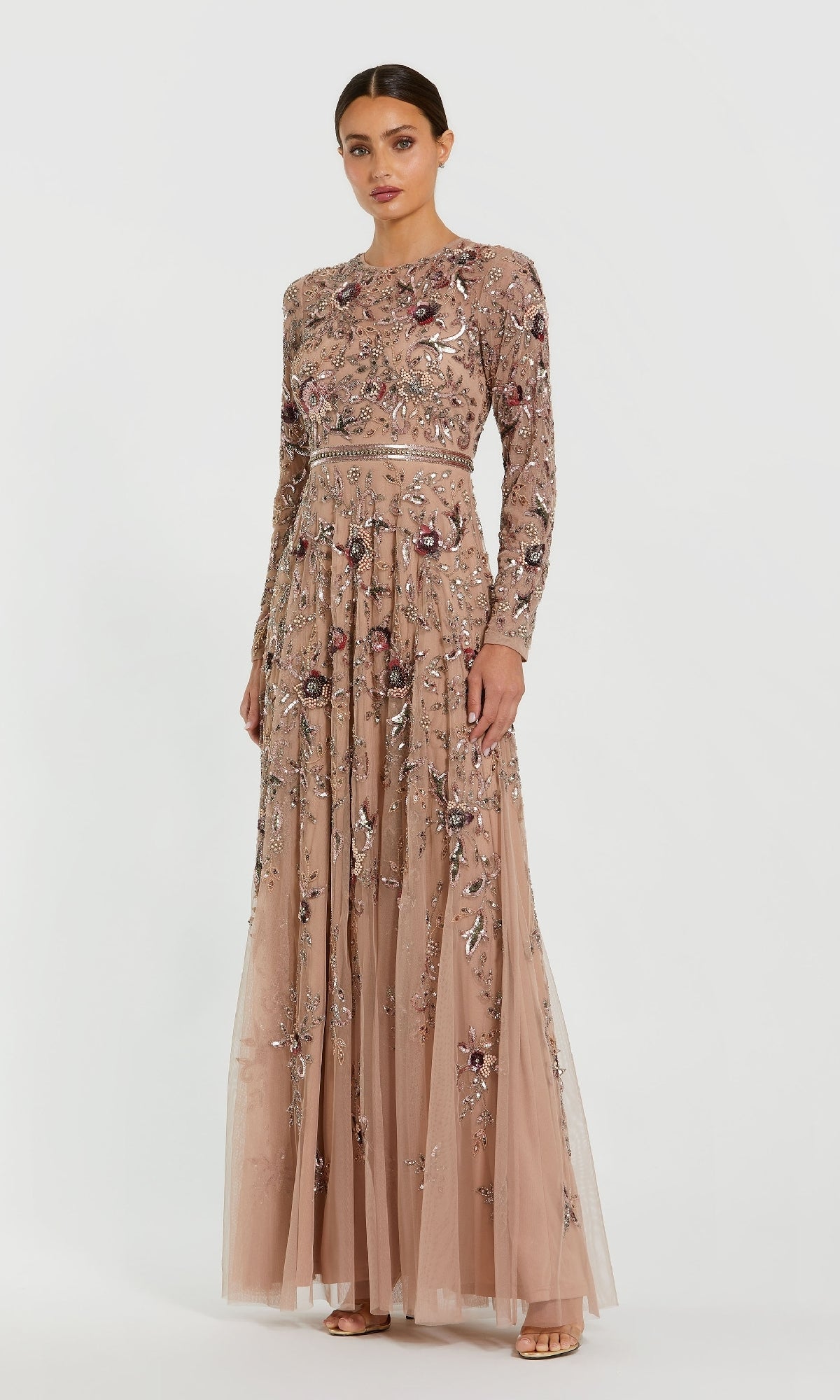 Woman wearing the Mac Duggal 10093 Long Sleeve Beaded Formal Dress, a floor-length gown with intricate beadwork, standing against a plain white background.