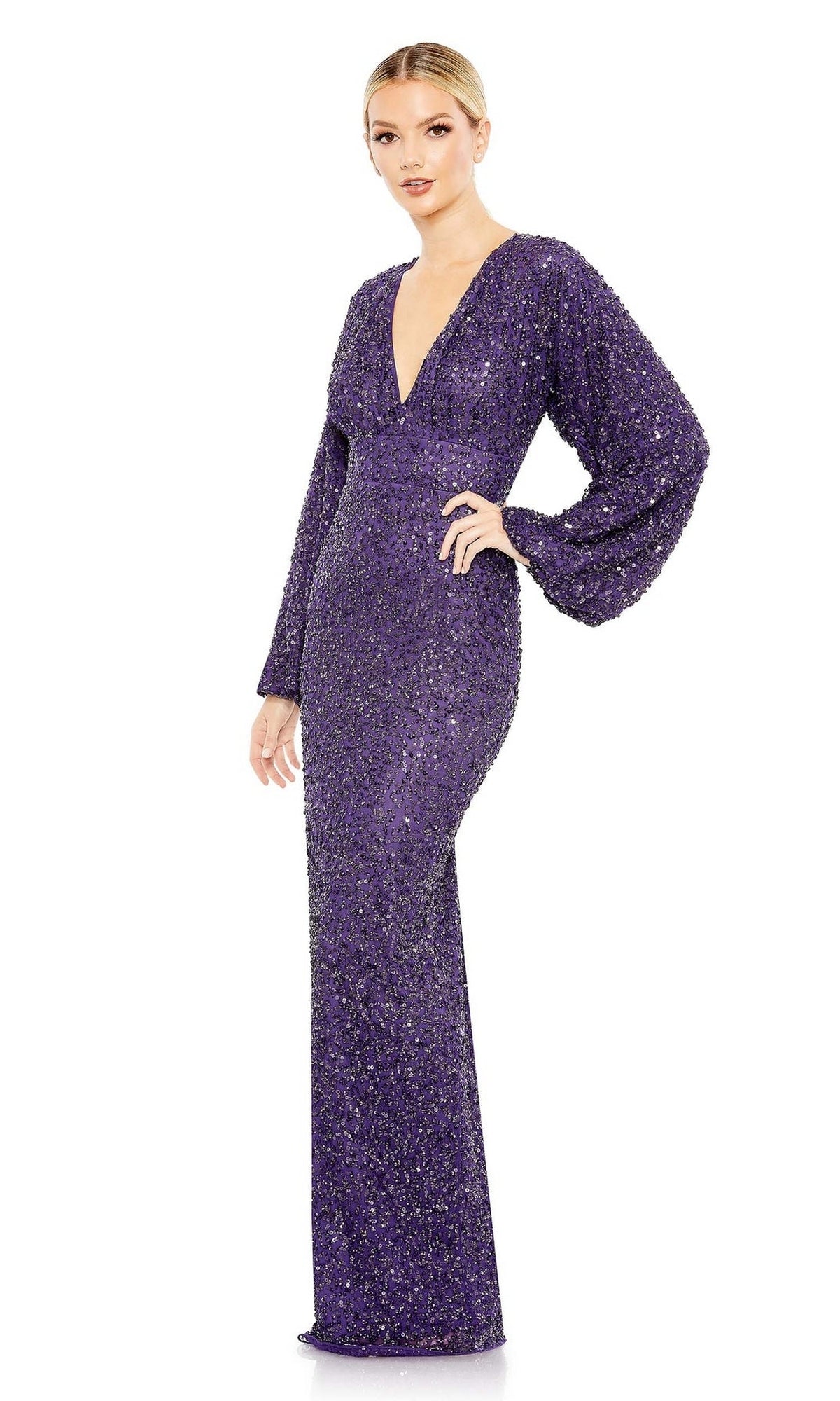 A woman poses against a white background wearing the Mac Duggal 10791 Sequin Long Sleeve Formal Gown, a floor-length purple evening dress featuring shimmering sequins and a deep V-neckline.