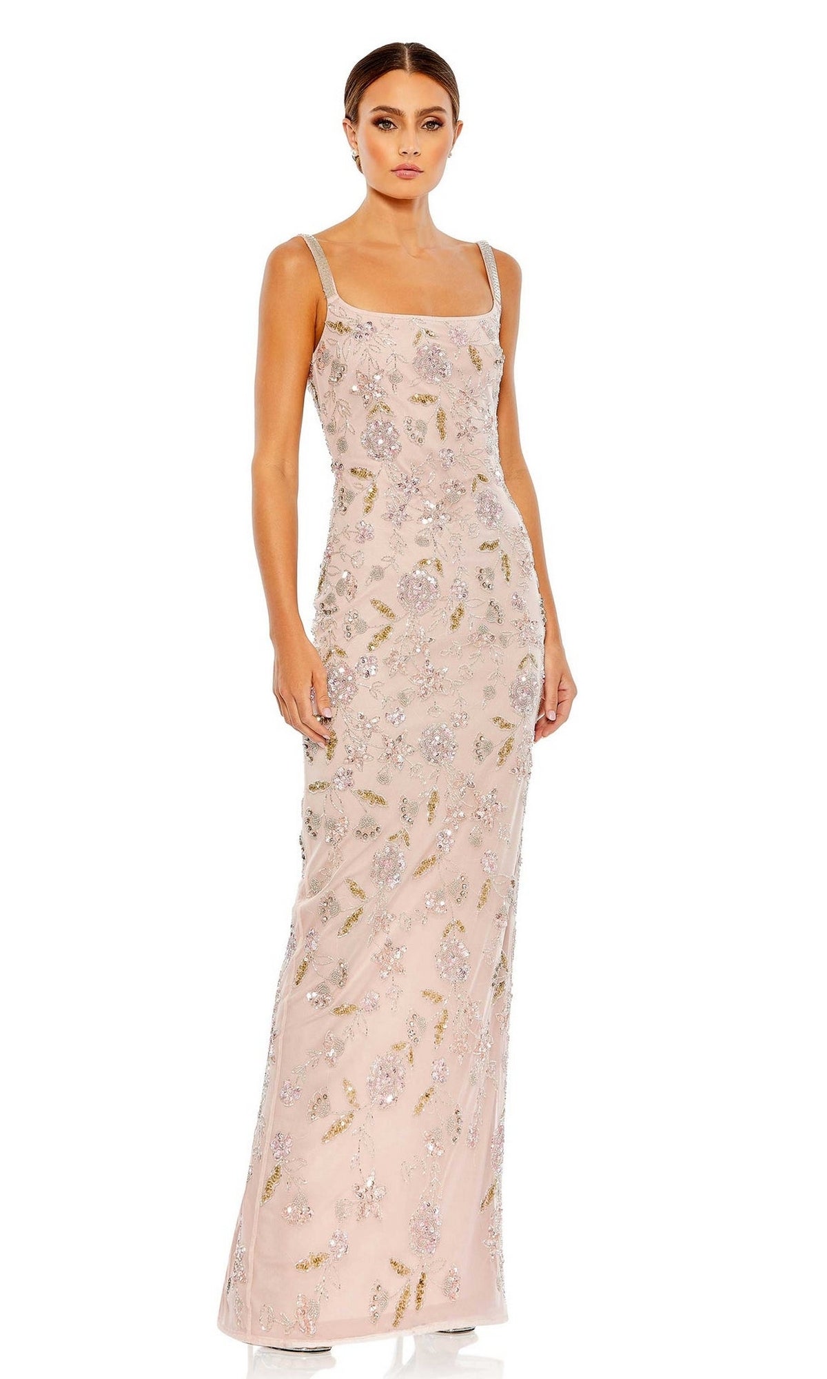 A woman stands wearing the Long Formal Dress 10808 by Mac Duggal, a sleeveless, floor-length light pink gown with silver and gold sequin floral embellishments.