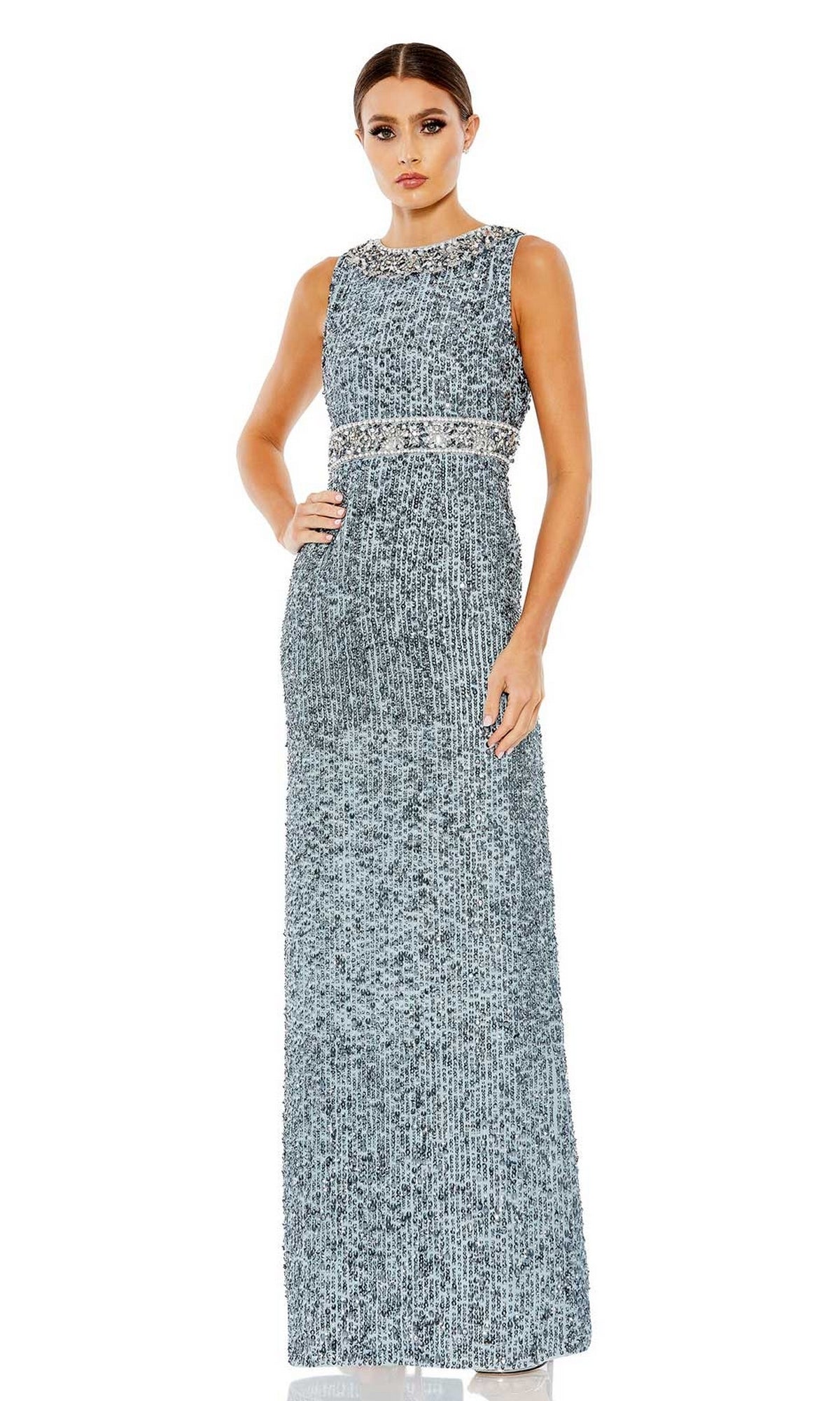 Woman wearing the Long Blue Sequin Formal Gown, Mac Duggal 10839—a sleeveless floor-length dress with a fitted waist—perfect for a glamorous mother of the bride, posing against a plain white background.