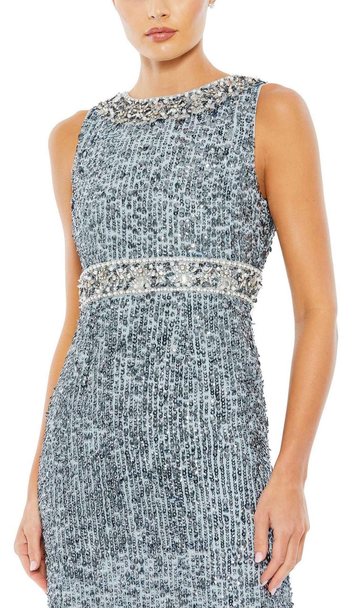A woman stands against a plain white background wearing the Mac Duggal 10839—a long blue sequin formal gown featuring beaded detailing at the neckline and waist, embodying refined mother of the bride elegance.