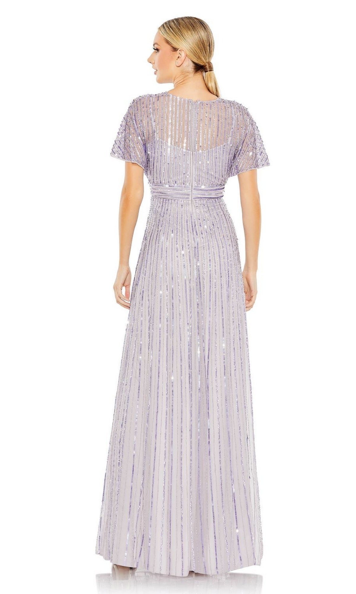 A woman faces away, wearing the Mac Duggal 10868—a purple long sequin formal dress featuring vertical stripes and sheer detailing on the upper back and shoulders.
