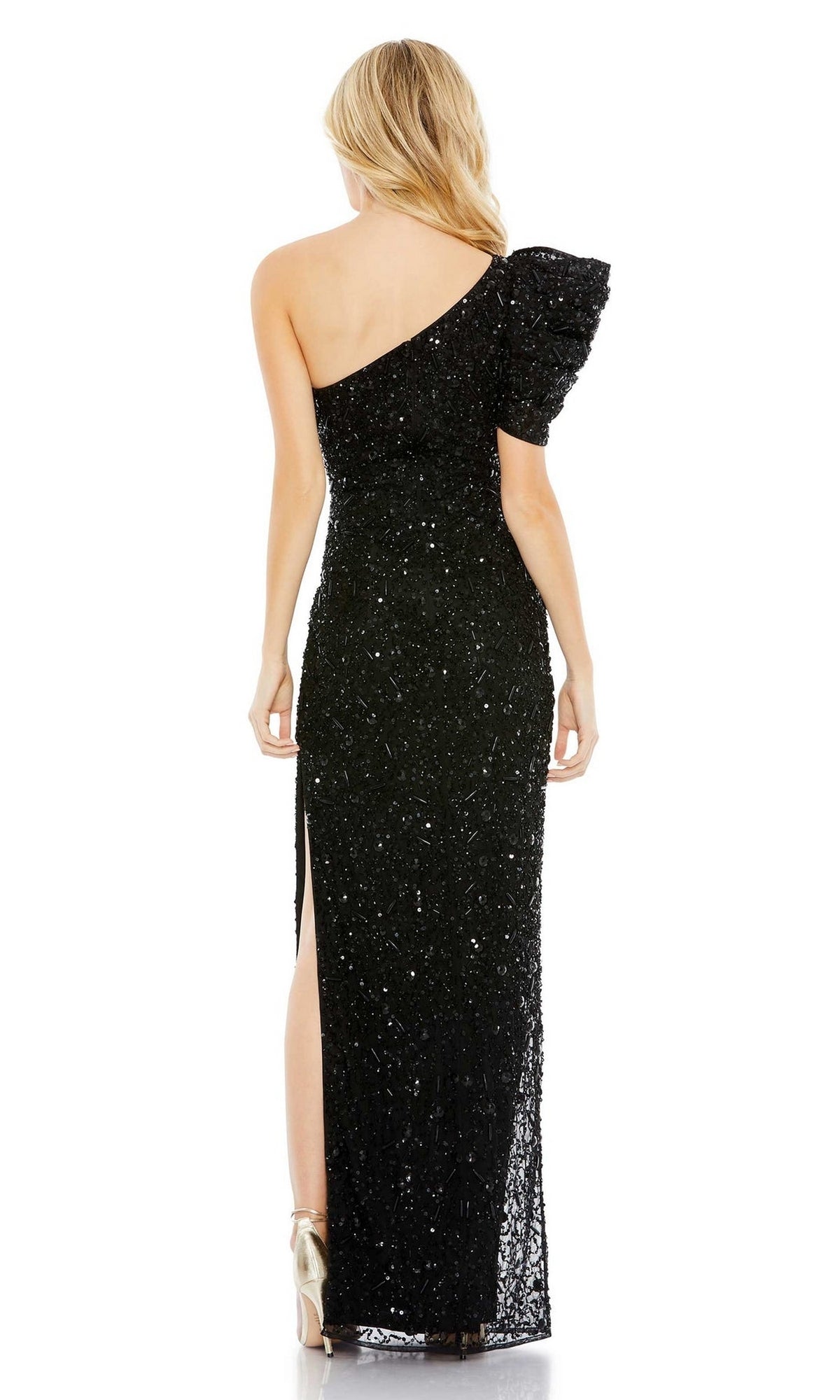 A woman stands with her back to the camera wearing the Mac Duggal Long Formal Dress 10912, a black, one-shoulder gown featuring sequins, a ruffled sleeve, and a side slit.
