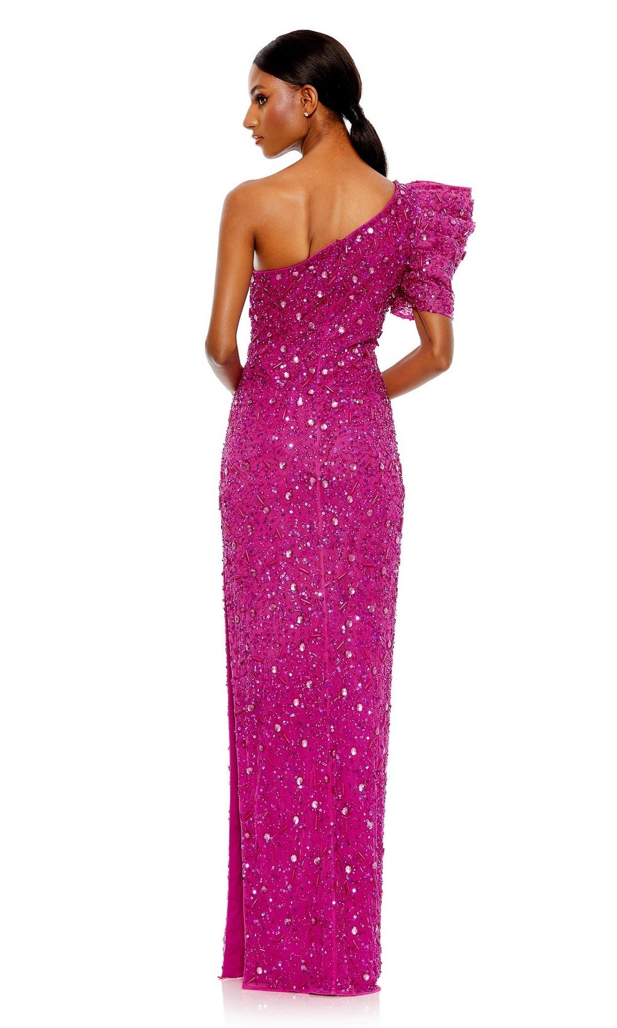 A woman stands facing away in the Long Formal Dress 10912 by Mac Duggal—a bright pink, floor-length, sequined, one-shoulder gown with a ruffled sleeve.