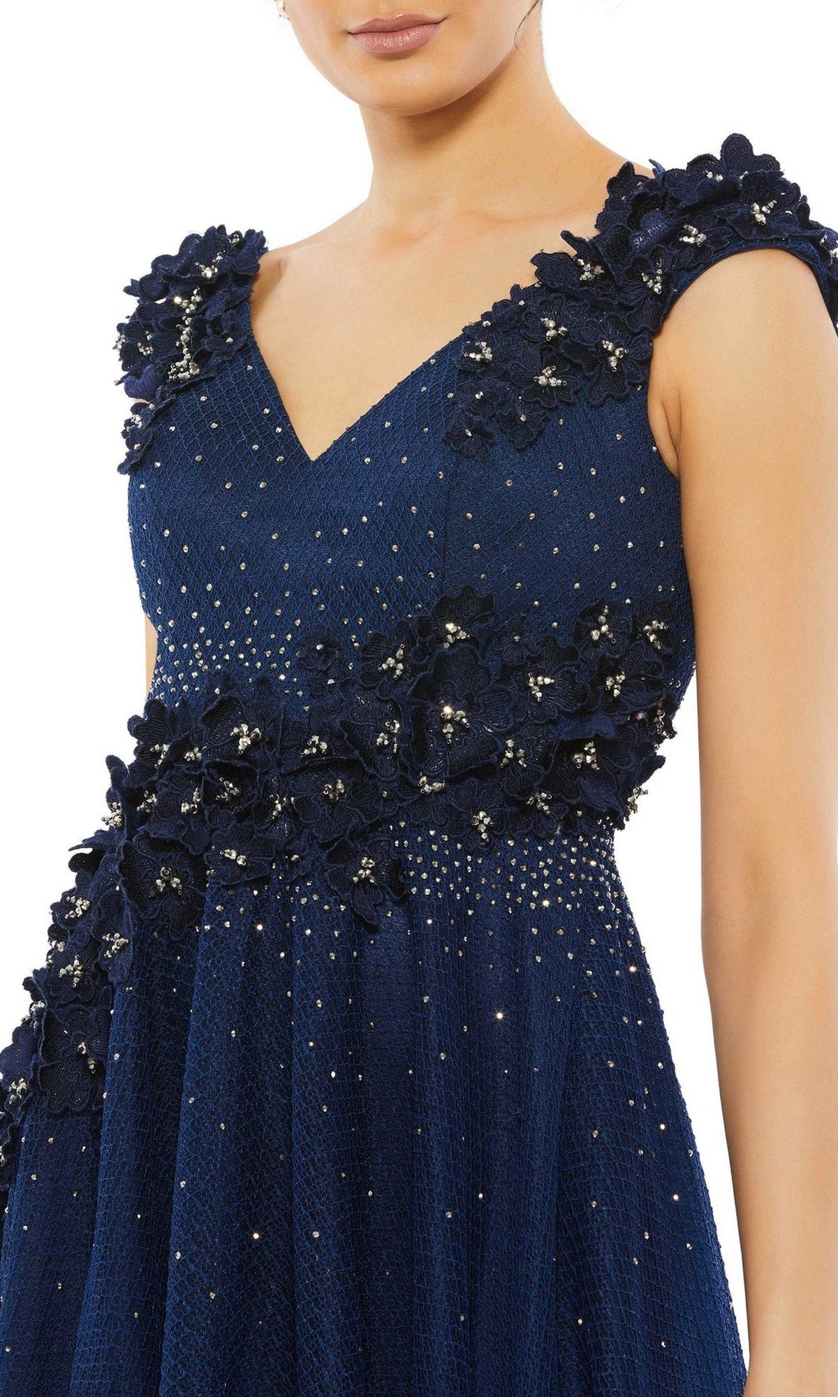 A woman wearing the Mac Duggal V-Neck Midnight Blue Formal Dress 11152, featuring textured fabric, cap sleeves, floral embroidery, and sparkling embellishments.