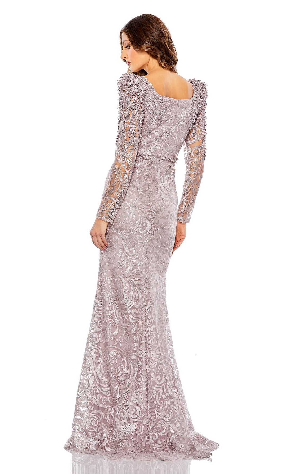 Woman wearing the Mac Duggal 11187 long sleeve formal gown in light lavender, featuring lace patterns, sheer sleeves, and embellished shoulders—an elegant evening dress perfect for mother of the bride, shown from the back.