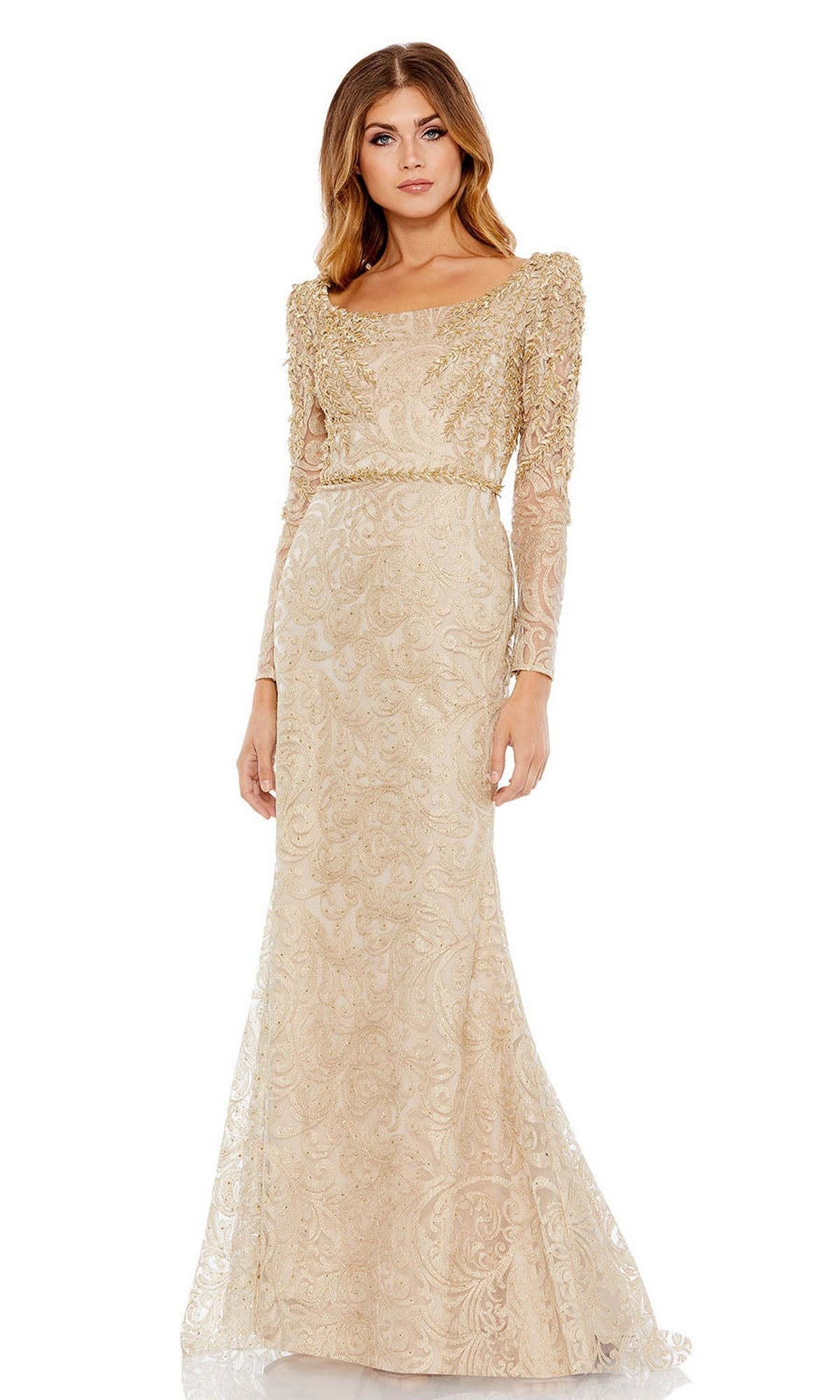 A woman wearing the Mac Duggal 11187 long sleeve formal gown—a fitted beige dress with intricate embroidery and beading, perfect as a mother of the bride outfit, featuring long sleeves and a slightly flared hem.