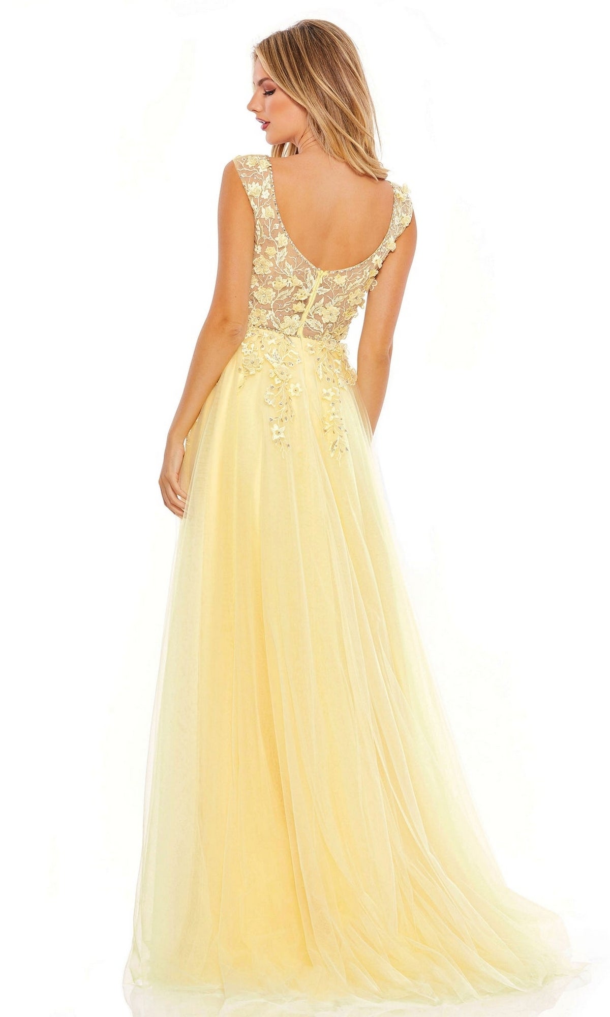 A woman stands with her back to the camera wearing the Long Formal Dress 11201 by Mac Duggal, a sleeveless yellow A-line design featuring a lace bodice, sheer back, and delicate floral embroidery.