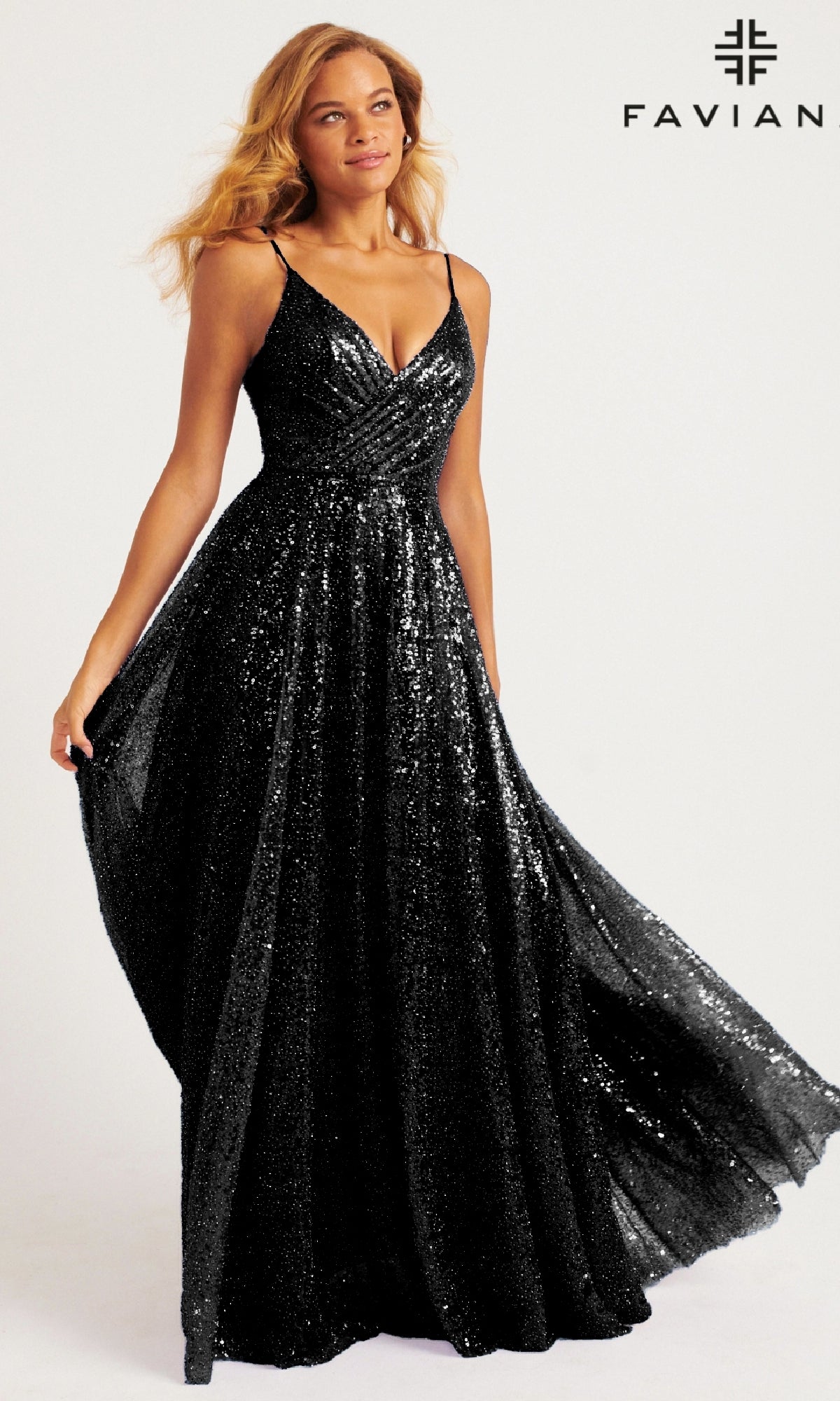 A woman wears the black Faviana 11203 Long Sequin A-Line Prom Dress, sleeveless and floor-length, posing before a plain background with the