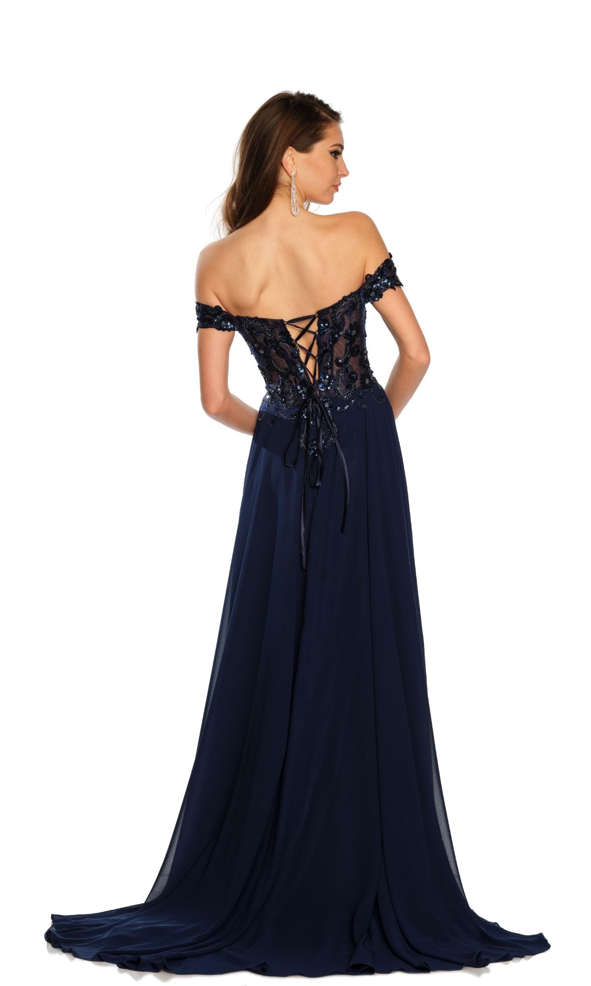 A woman models the Dave and Johnny Off-Shoulder Navy Prom Dress 11242, featuring floral bodice embellishments, lace-up back, and a flowing skirt, against a white background.