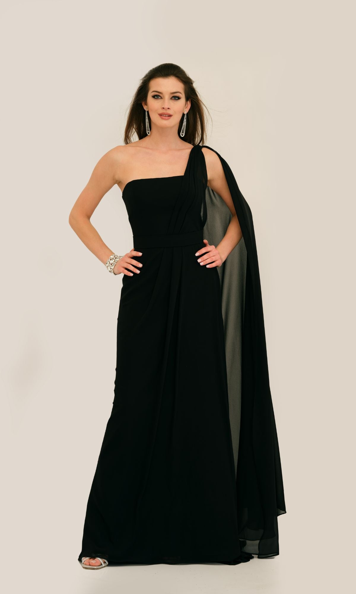 Woman in the Caped Strapless Long Prom Dress (Dave & Johnny 11288) stands against a plain background, accessorized with earrings, bracelet, and open-toe heels.