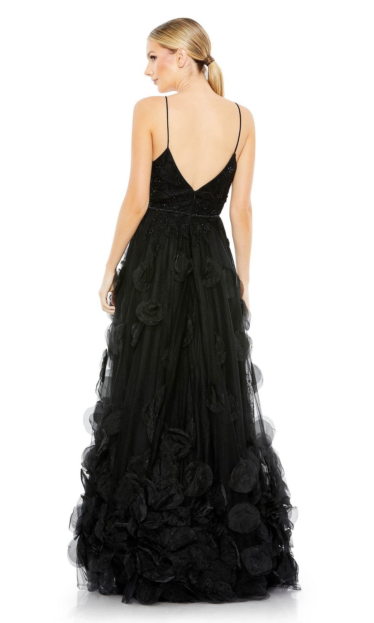 A woman models the Mac Duggal 11293 Long Black Floral Formal Dress, featuring a sweetheart neckline, low back, and floral appliqué details, elegantly showcasing this sophisticated evening gown from behind.