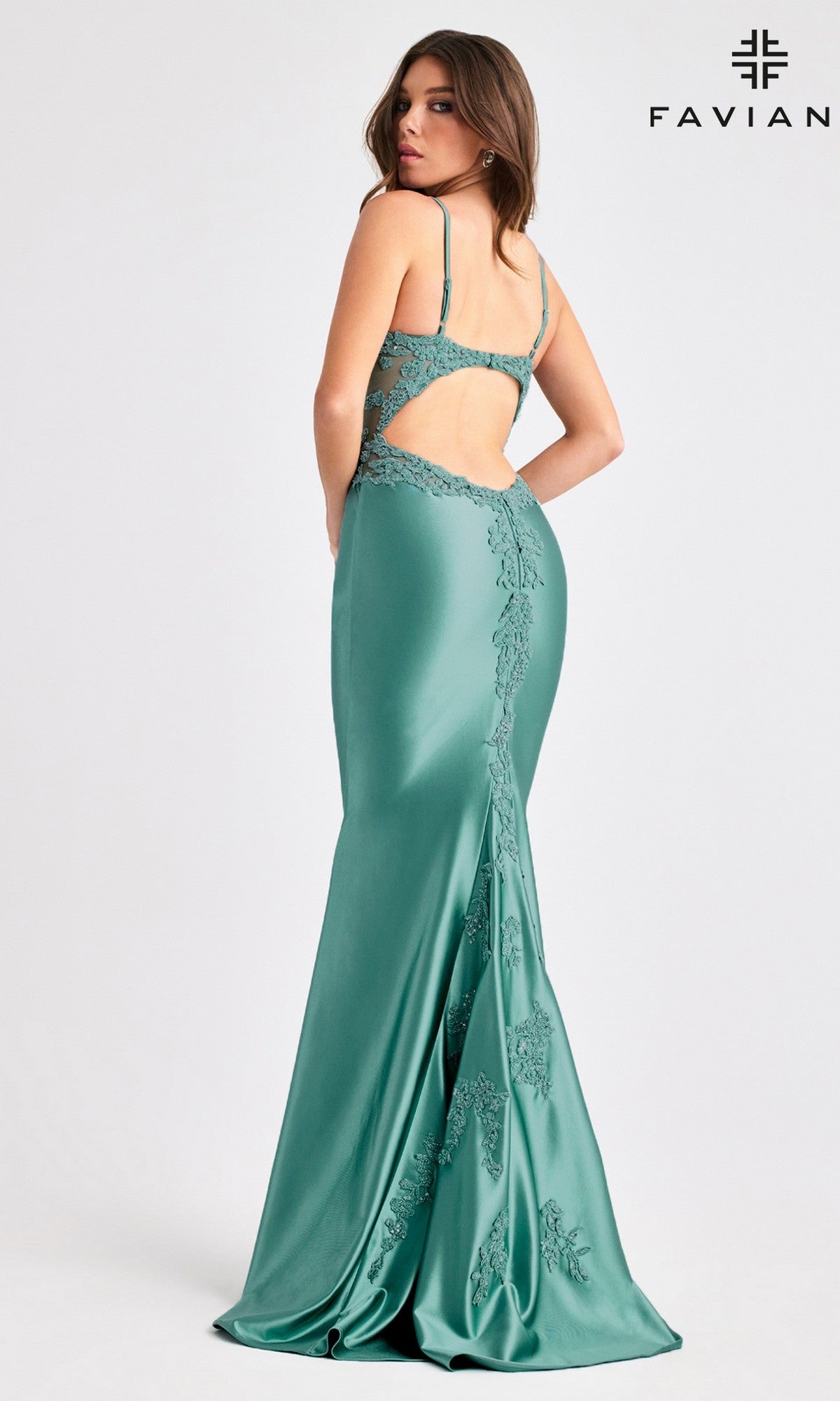 A woman wearing the Faviana 11403, a floor-length sleeveless green prom dress with lace details and open back, stands looking over her shoulder. The Faviana logo appears in the top right corner.
