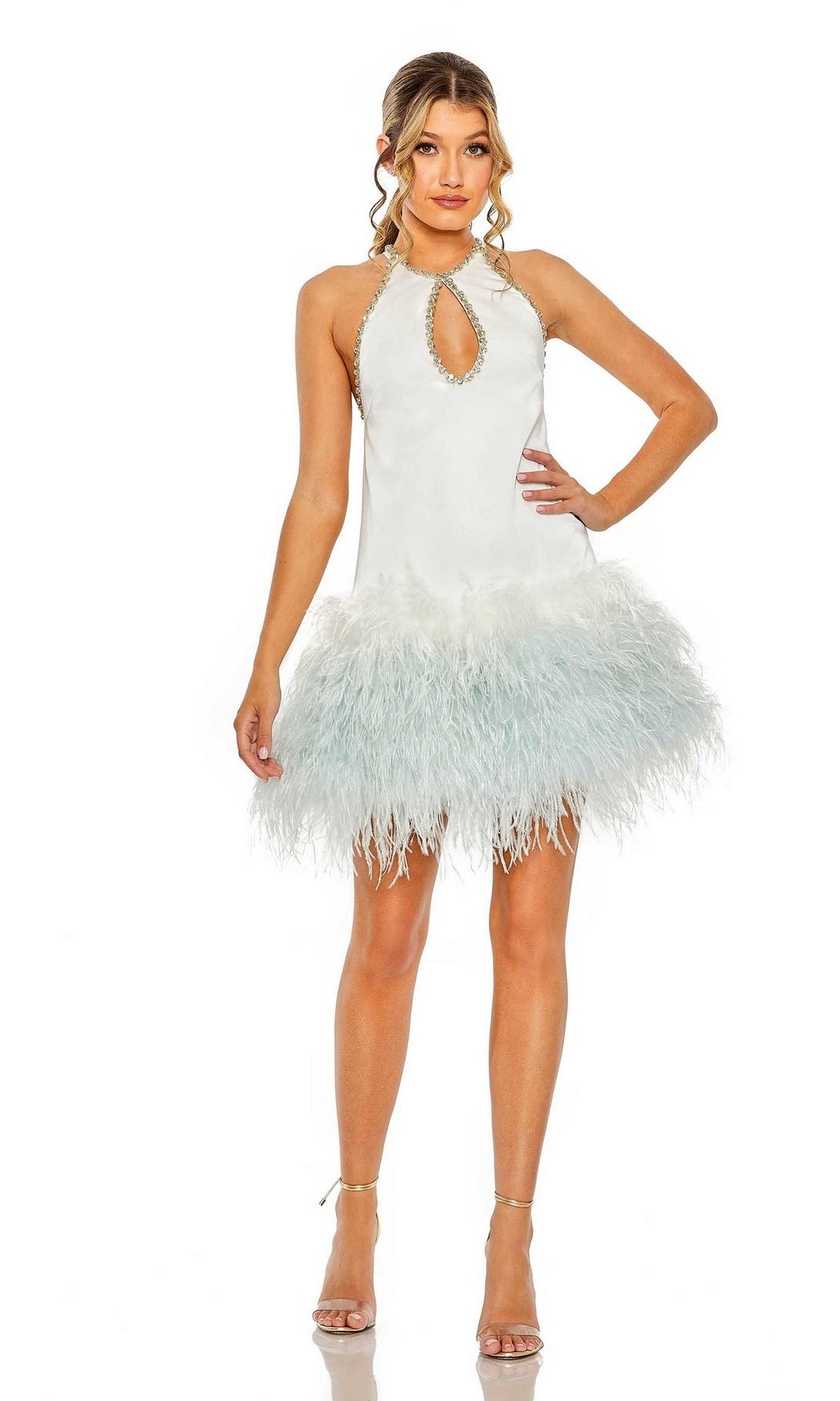 A woman models the Mac Duggal Short Homecoming Dress 11437, featuring a chic white keyhole cutout, halter neckline, feathered skirt, and paired with strappy high-heeled sandals.