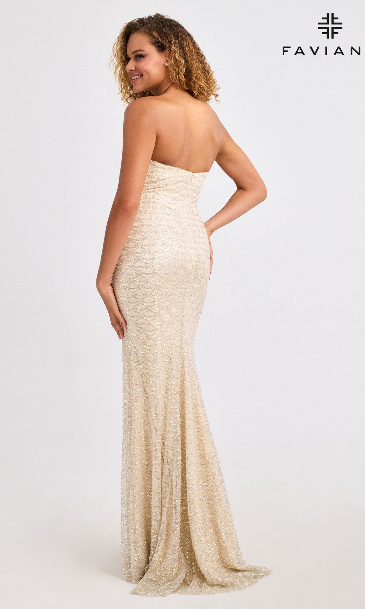 A woman models the Faviana 11446 long prom dress—a strapless, floor-length gold gown with scalloped beading—standing against a plain white background.