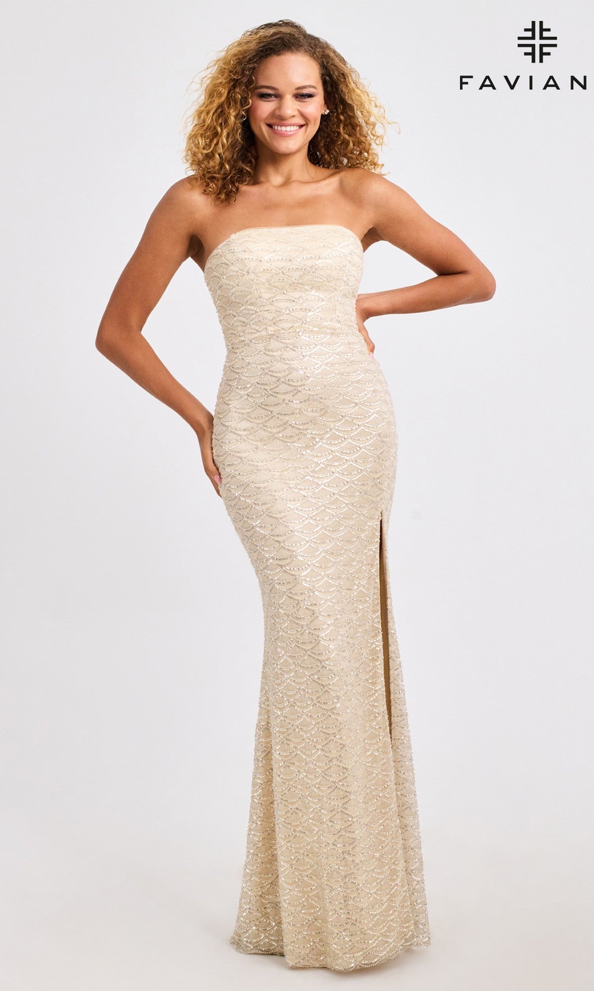 A woman smiles in a Long Prom Dress: Faviana 11446—strapless, floor-length, light gold with scalloped beading and a high slit—standing against a plain background. The Faviana logo appears in the top right corner.