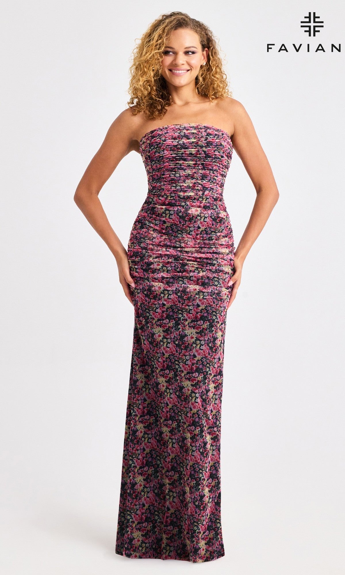 A woman wears the Faviana 11461 long prom dress, featuring a ruched floral print, strapless neckline, and floor-length hem. The background is plain white with the