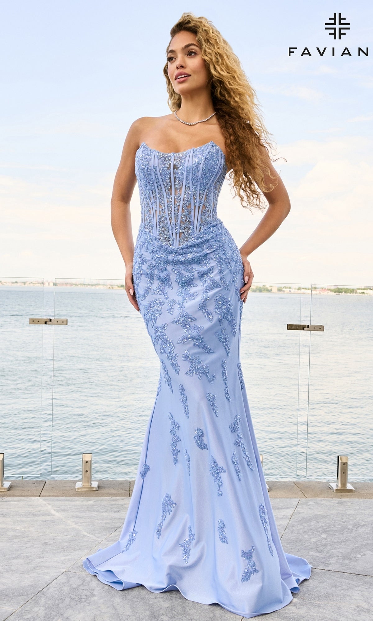 Faviana 11600 is a strapless light blue corset gown featuring a semi-sheer bodice and floral embroidery in a floor-length silhouette.