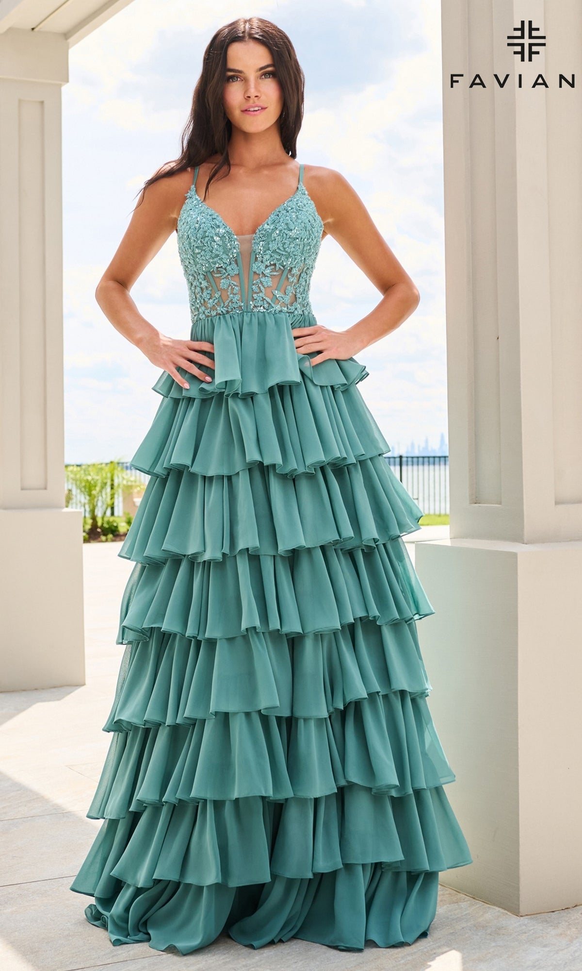 A model wearing the teal Faviana 11603 A-line prom dress with a corset bodice and a tiered ruffled skirt.