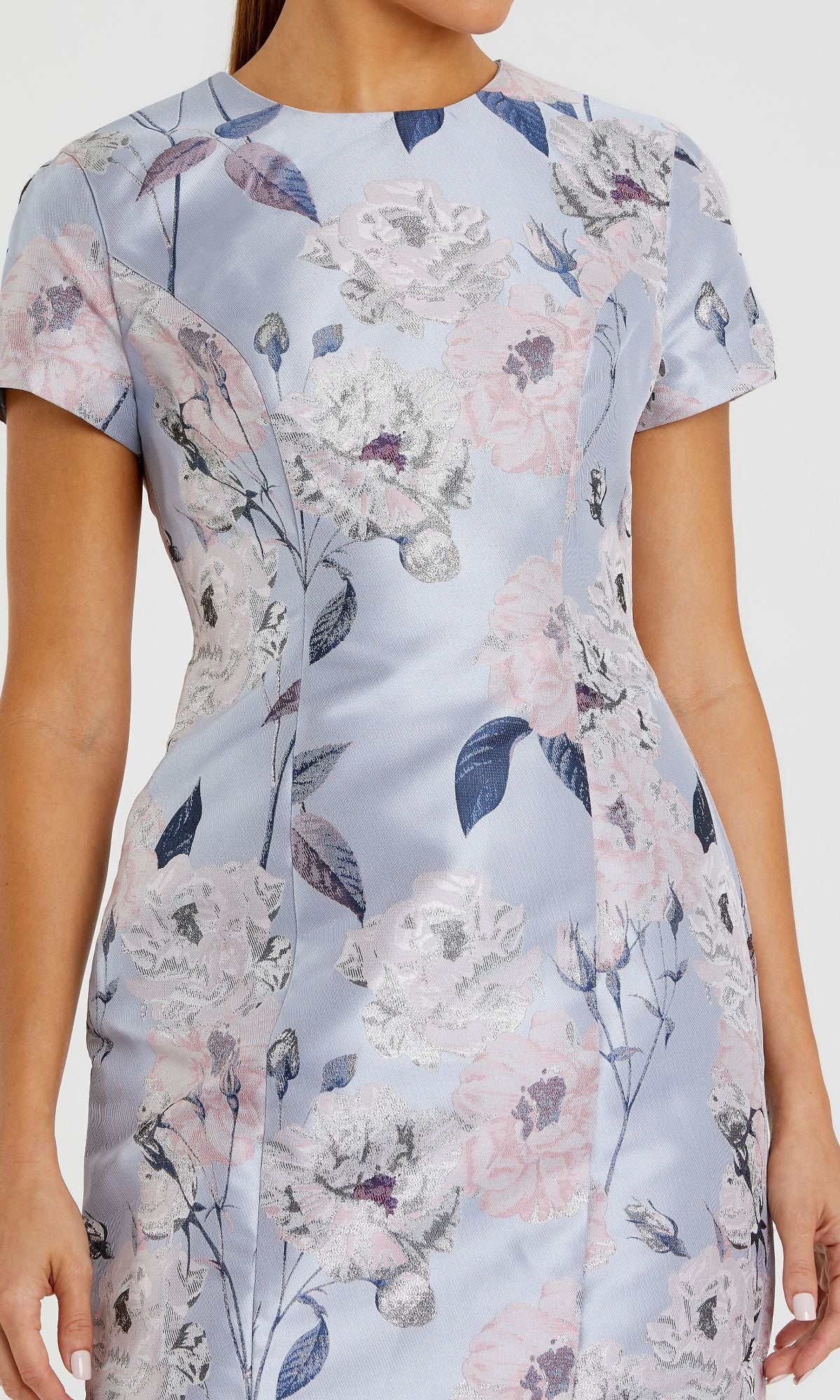 Someone in a light blue, short-sleeved Mac Duggal Floral-Print Wedding-Guest Dress 11614 with pink and white floral patterns.