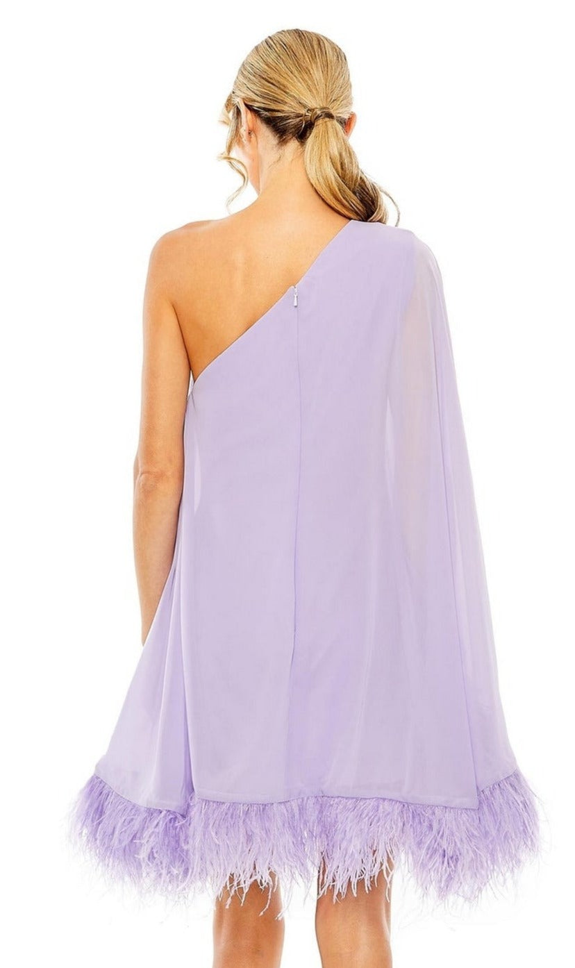 A woman with blonde hair in a low ponytail is seen from the back wearing the Mac Duggal 11623 short wedding guest dress, a one-shoulder light purple style with a feather-trimmed hem.