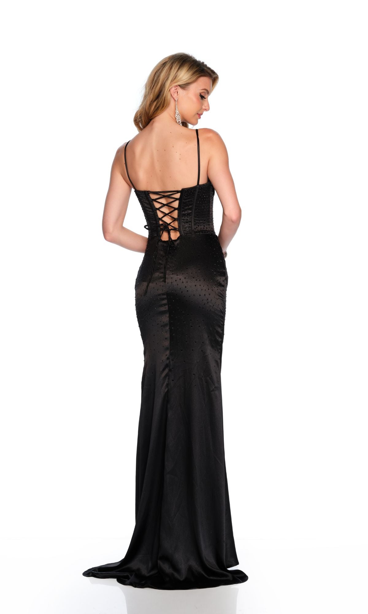 A woman stands facing away against a white background, wearing the Long Formal Dress 11647 by Dave and Johnny, a fitted black gown featuring a lace-up back detail.