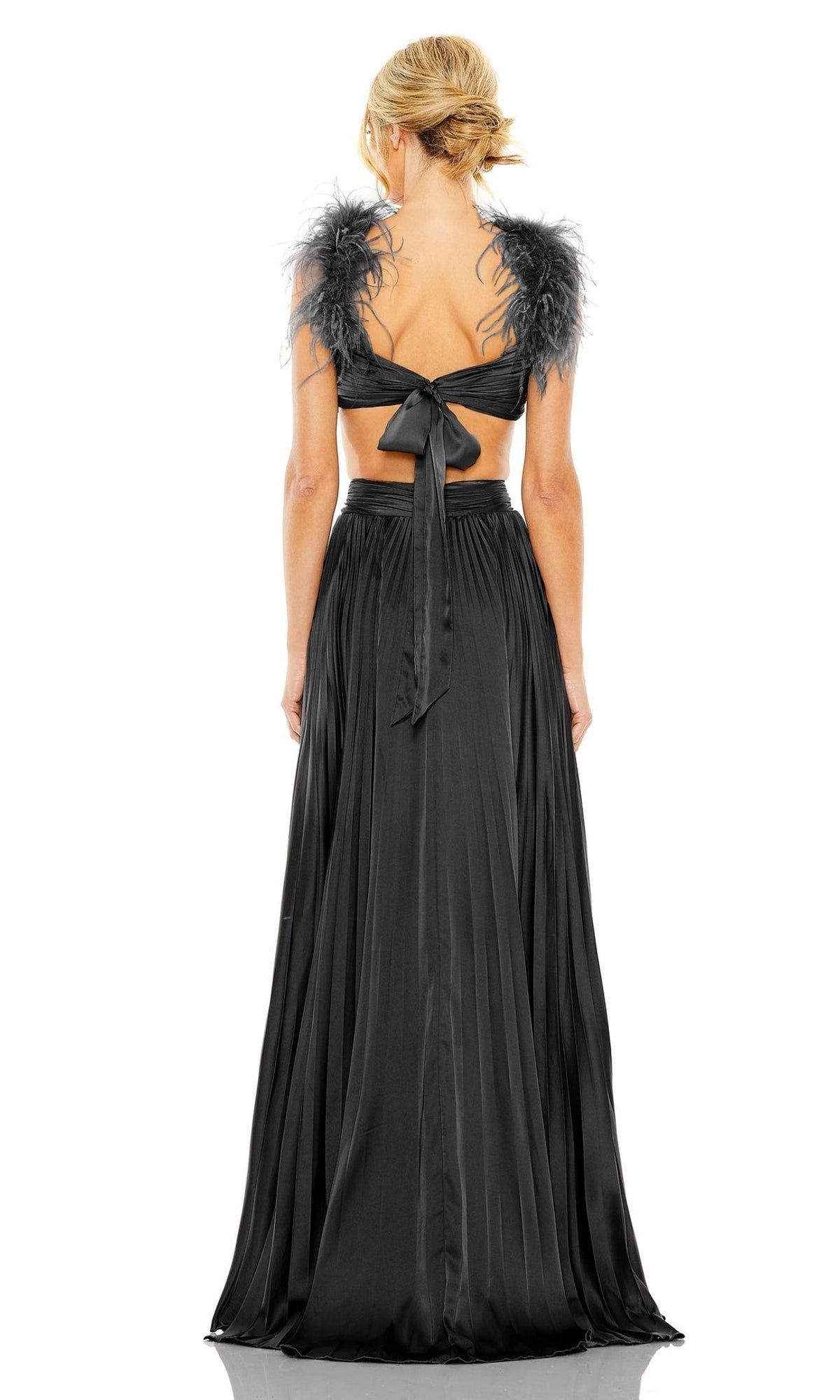 Woman wearing the Mac Duggal Pleated Cut-Out Black Formal Dress 116871, featuring feathered cap sleeves, an open back, and a bow tie at the waist, stands with her back to the camera.