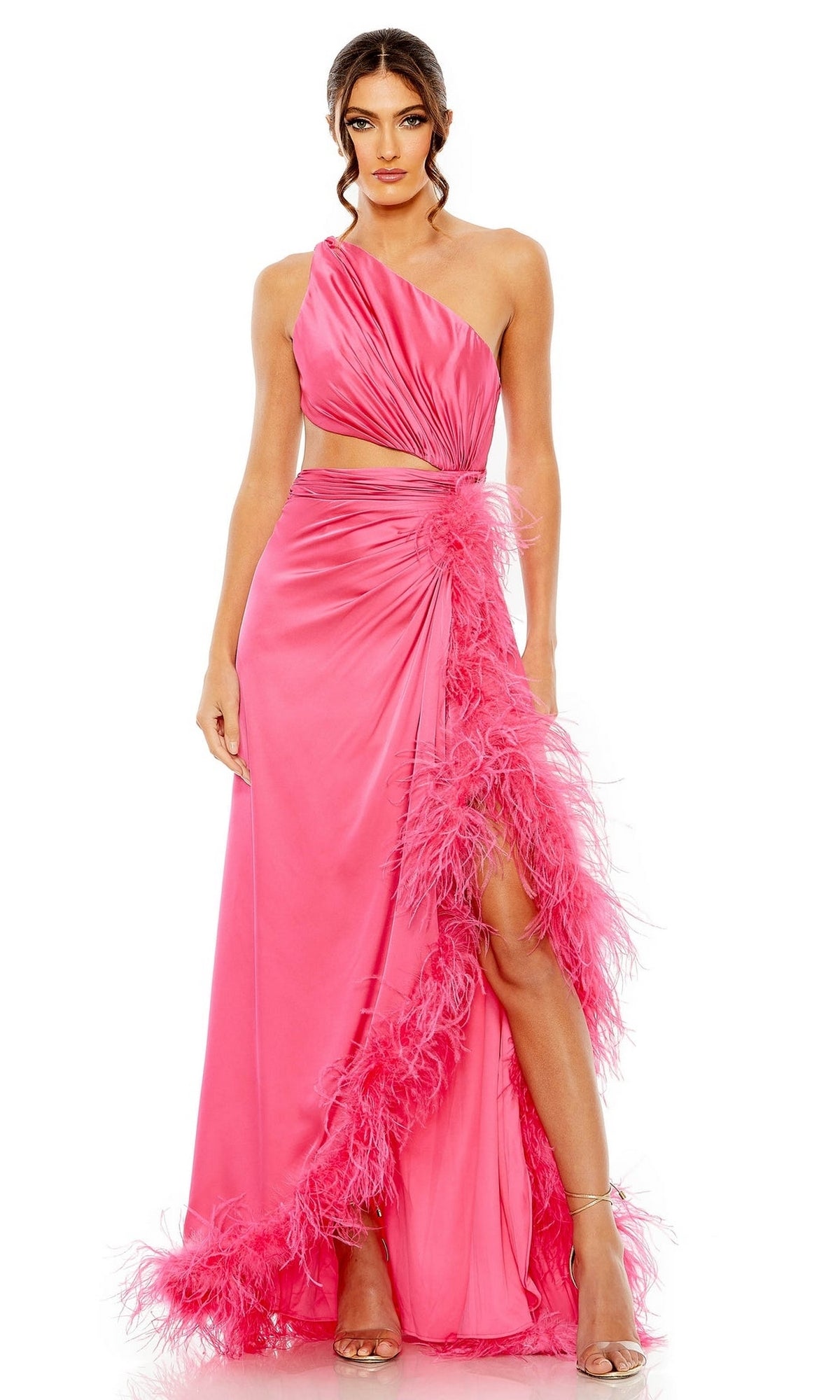 A woman stands against a white background wearing the Mac Duggal 11689 Feather Long Neon Formal Dress—one-shoulder, bright pink, with feather trim and a thigh-high slit.