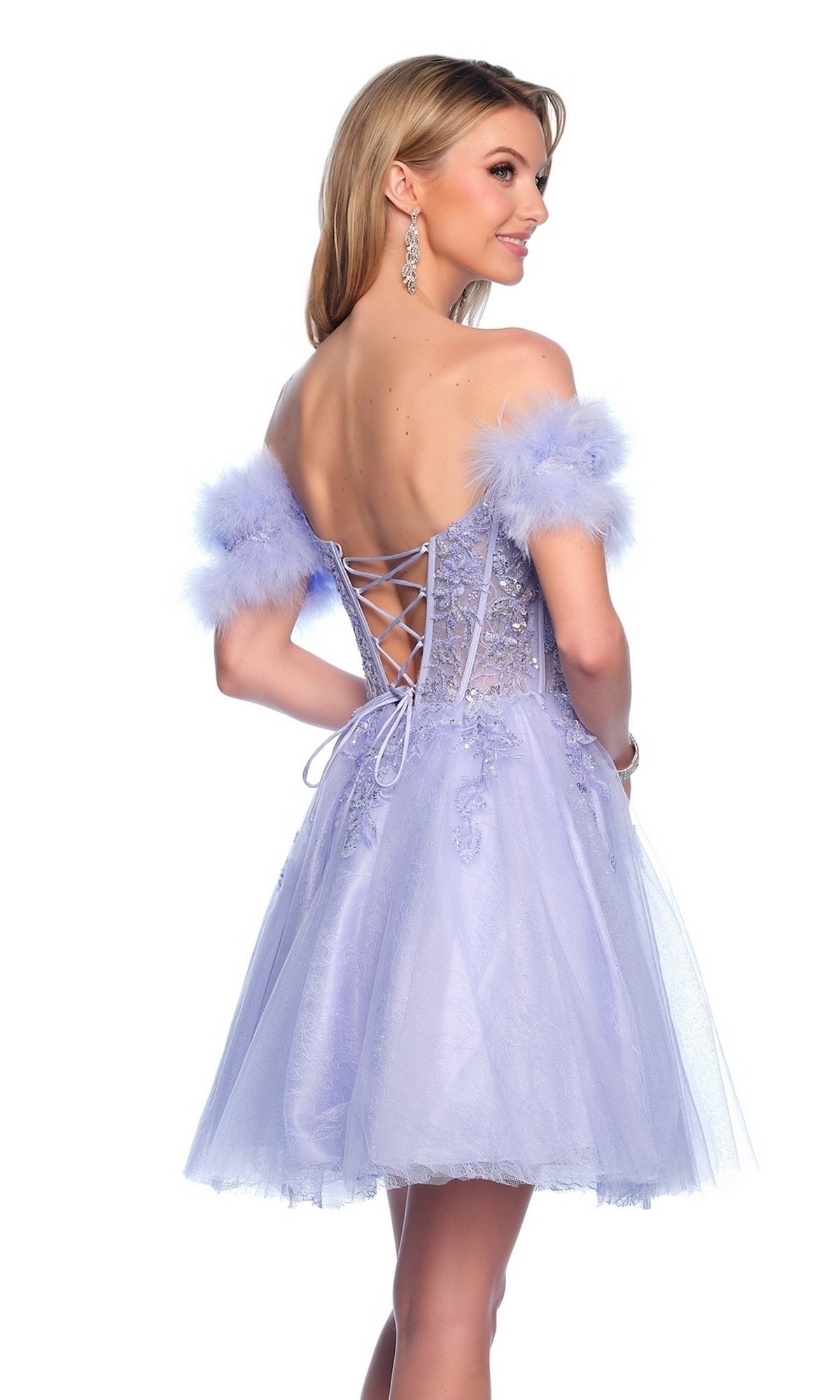 A woman stands looking over her shoulder, wearing the Dave & Johnny Feather Short Hoco Dress 11775, featuring off-the-shoulder feathered sleeves, a beaded sheer corset with lace-up back, and a tulle skirt.