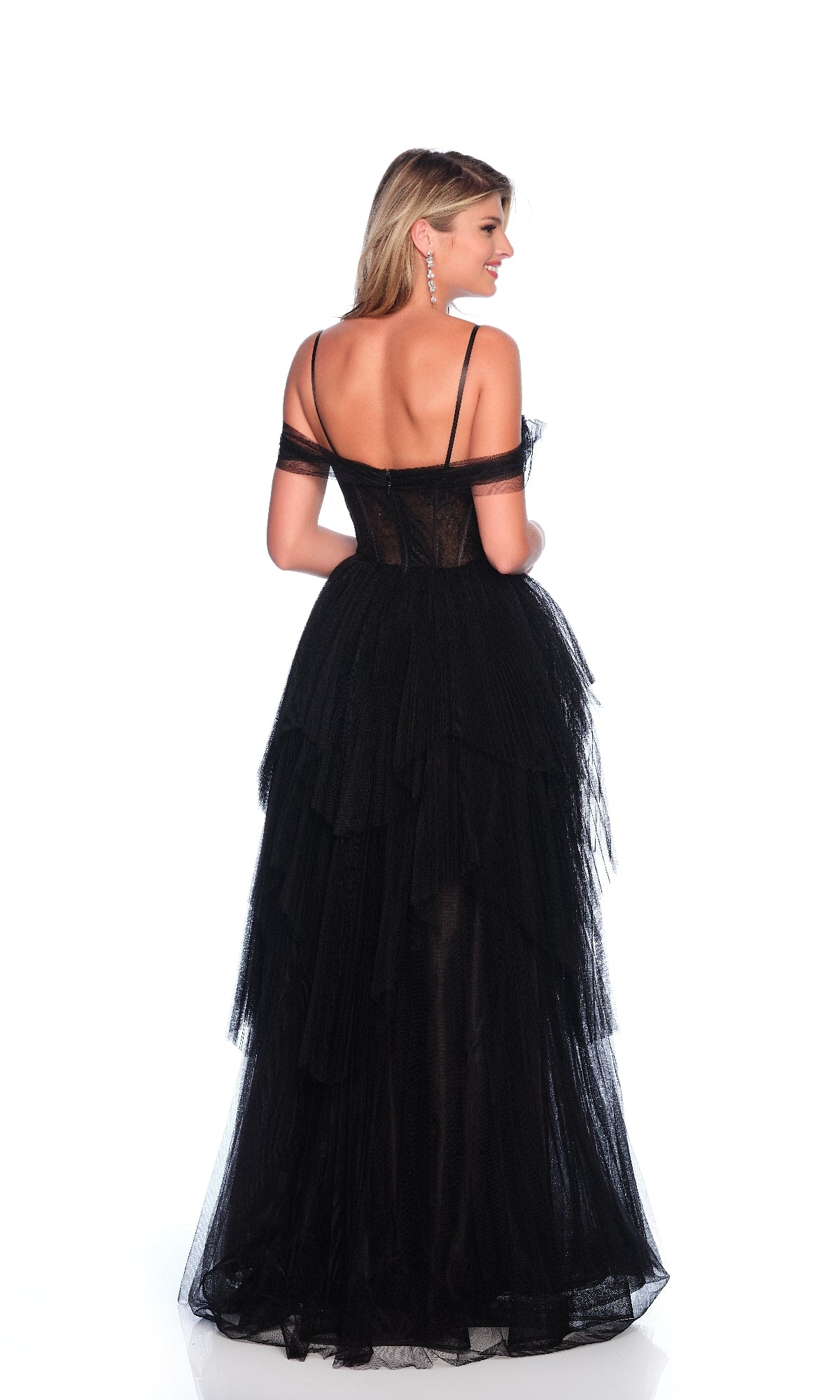 A woman faces away, wearing the Sheer-Corset Prom Ball Gown: Dave & Johnny 11854—a floor-length, tiered black tulle dress with off-the-shoulder straps—against a plain white background.