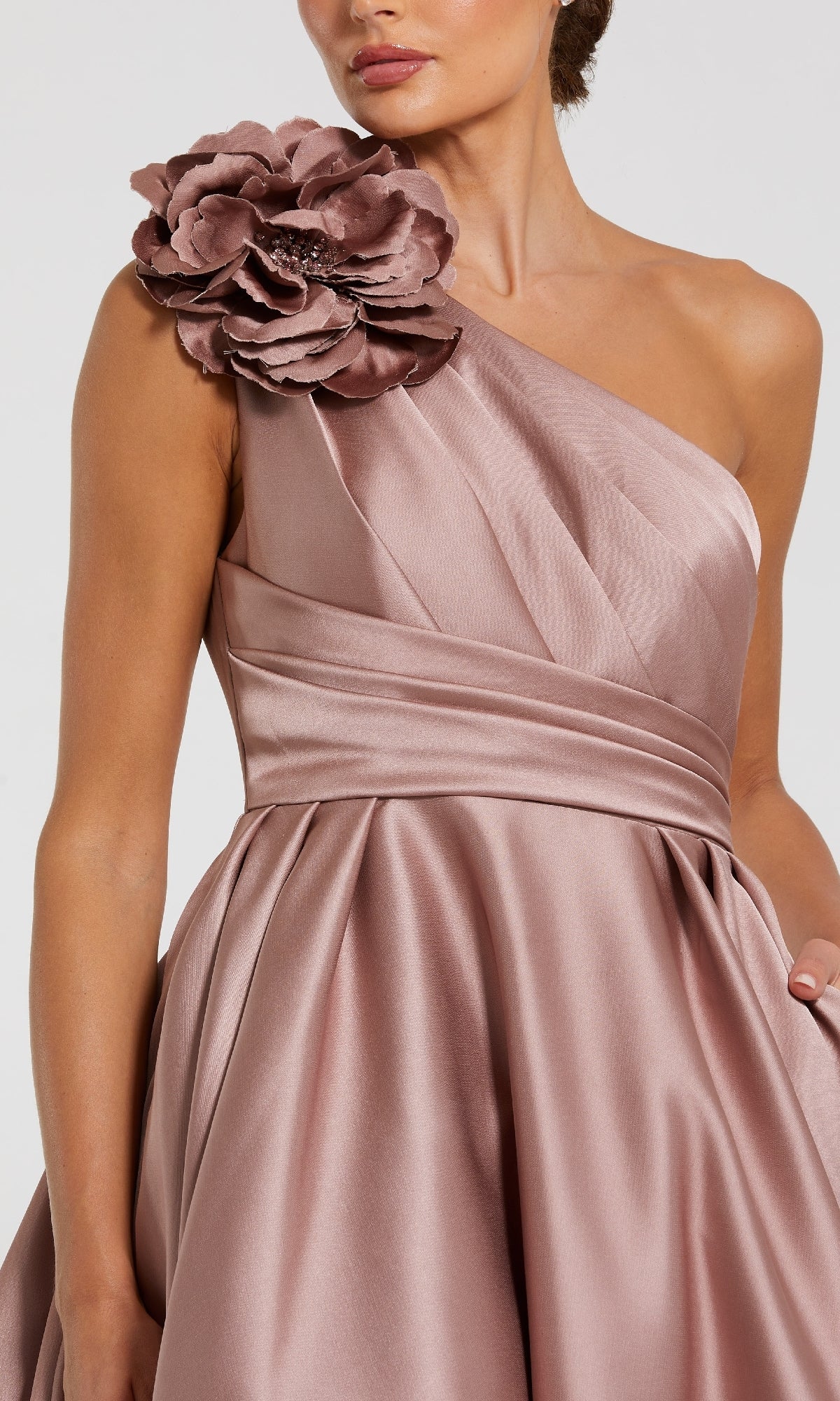 Rose pink one-shoulder dress with a large floral detail on a white background