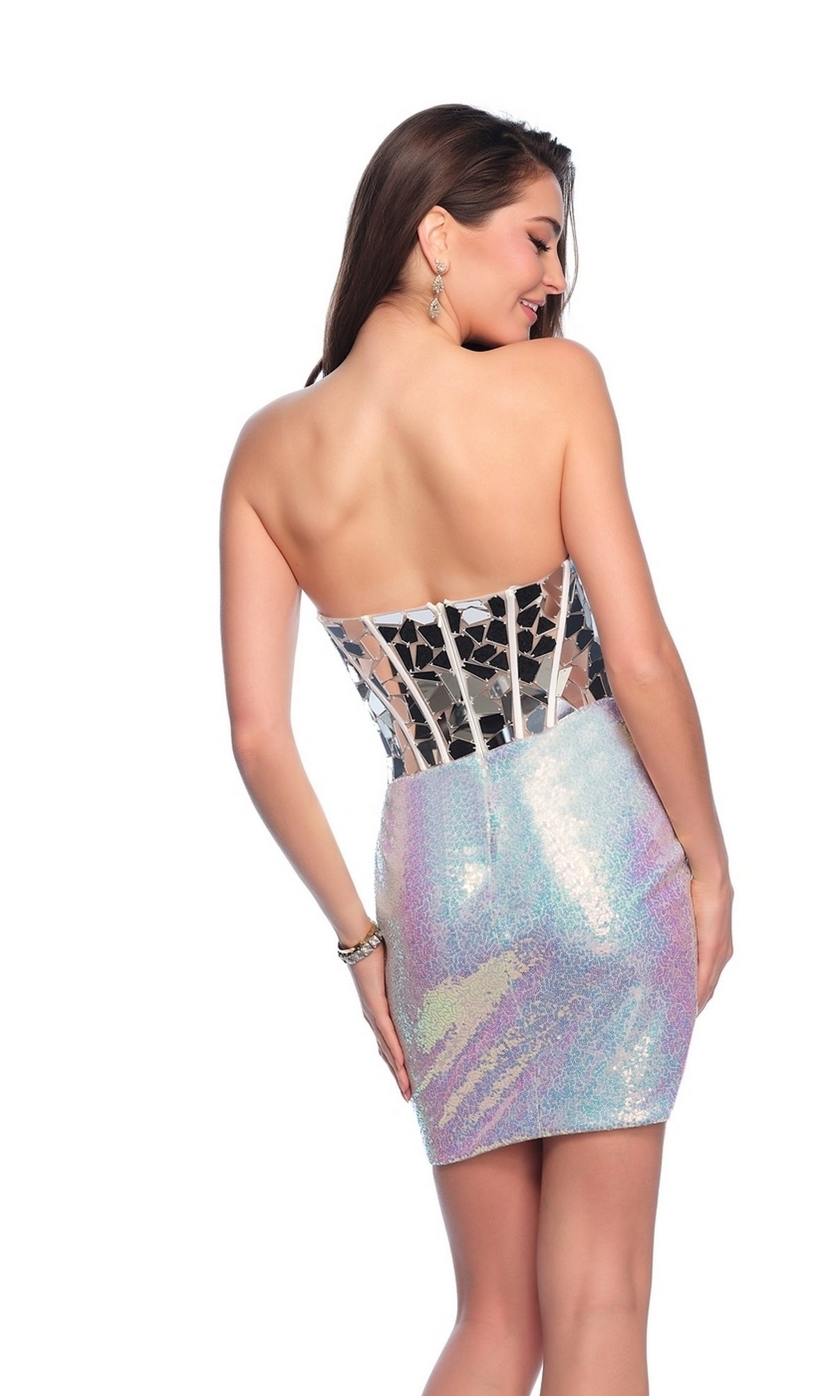 A woman in the Sequin Silver Homecoming Dress 12034, featuring a strapless design, iridescent finish, and sheer lace corset back, stands looking over her shoulder.