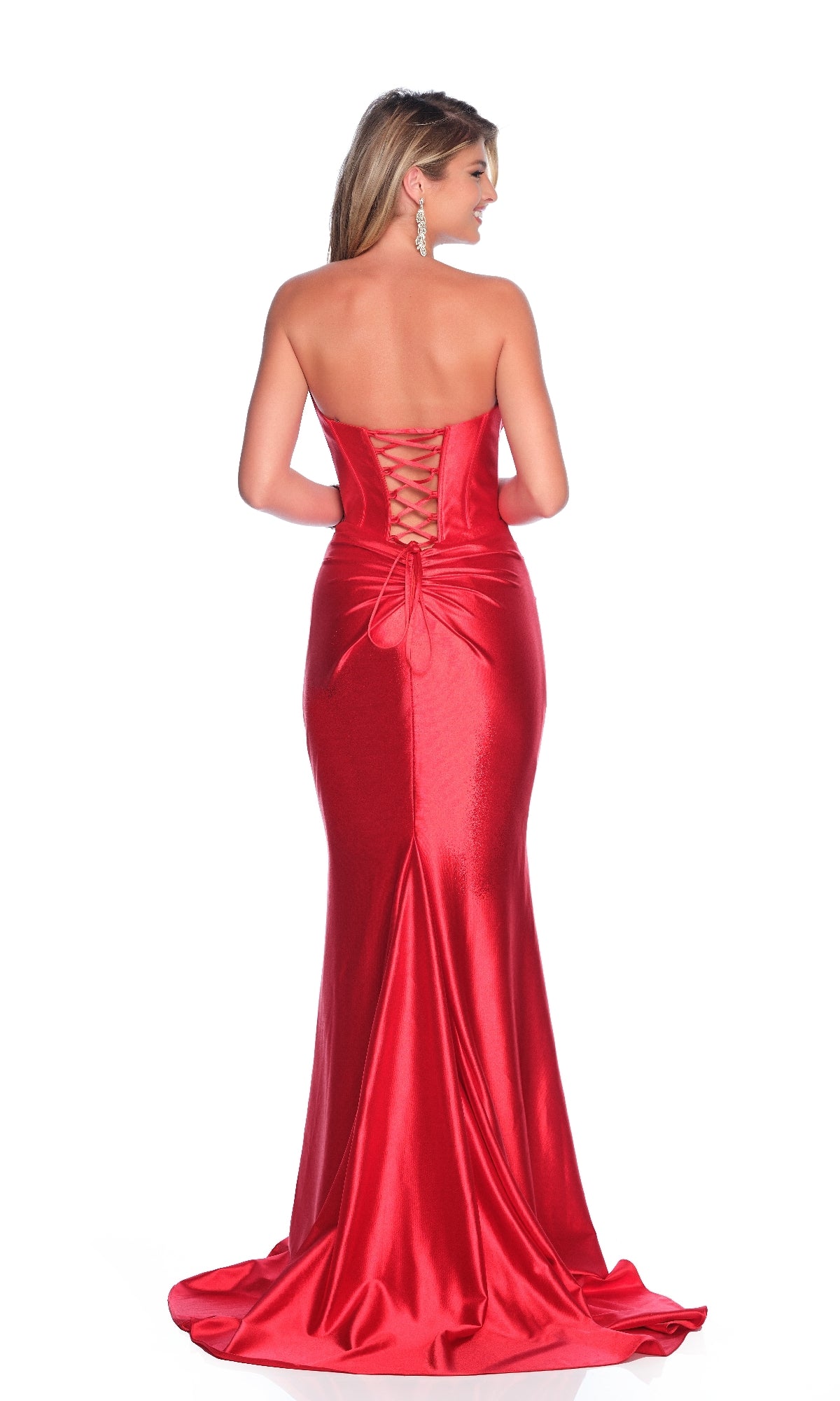 A woman models the Dave & Johnny 12099 Strapless Red Prom Dress, featuring a corset bodice and lace-up back, as she stands facing away from the camera against a white background.