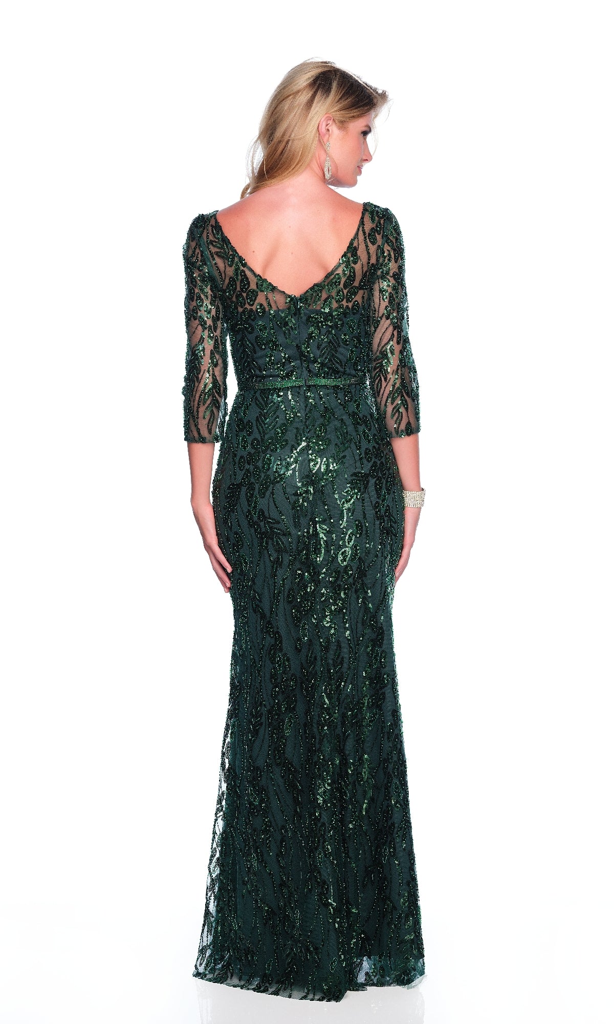 A woman stands facing away, wearing the Dave & Johnny 12317 long sleeve formal dress in dark green with a V-back and sequin embellishments.