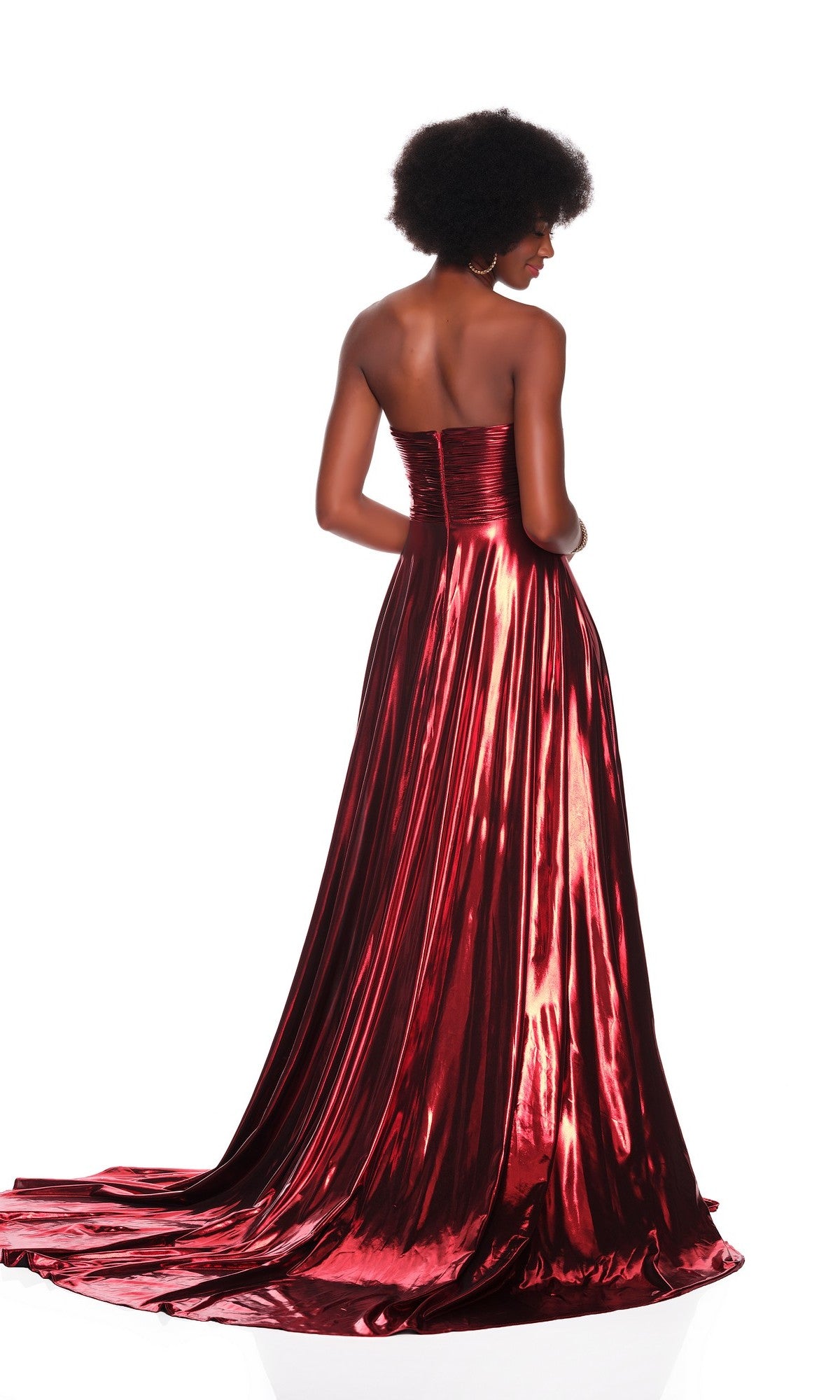 A woman with short curly hair models the Dave & Johnny 12328 metallic prom dress, which has a strapless ruched fitted bodice and floor-length train, shown from the back against a white background.