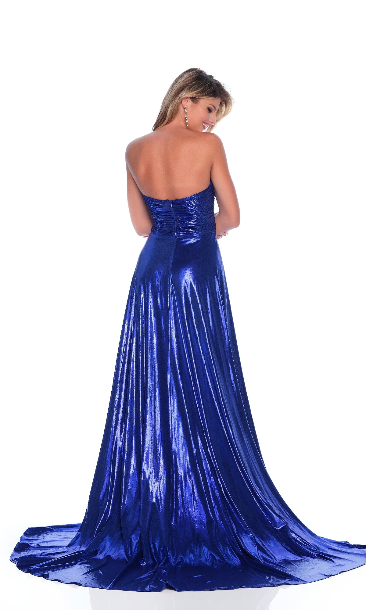 A woman in the Dave & Johnny 12328 metallic prom dress stands with her back to the camera, highlighting its strapless, ruched fitted bodice and sweetheart neckline. The floor-length blue gown is showcased against a white background.