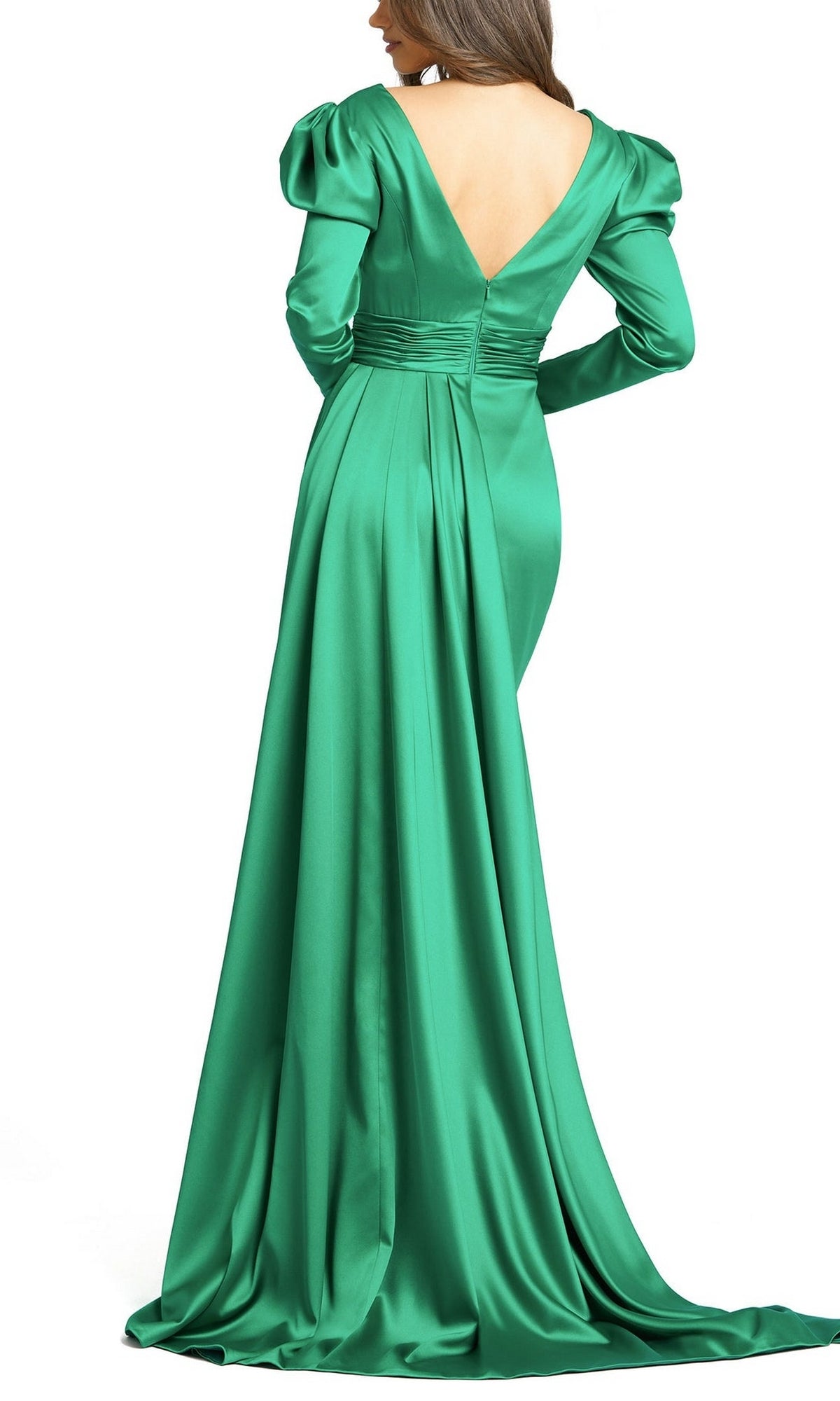 A woman wears the Long Formal Dress 12404 by Mac Duggal—an emerald green satin gown with long sleeves, a deep V-back, gathered waist, and a flowing train—as she stands facing away.