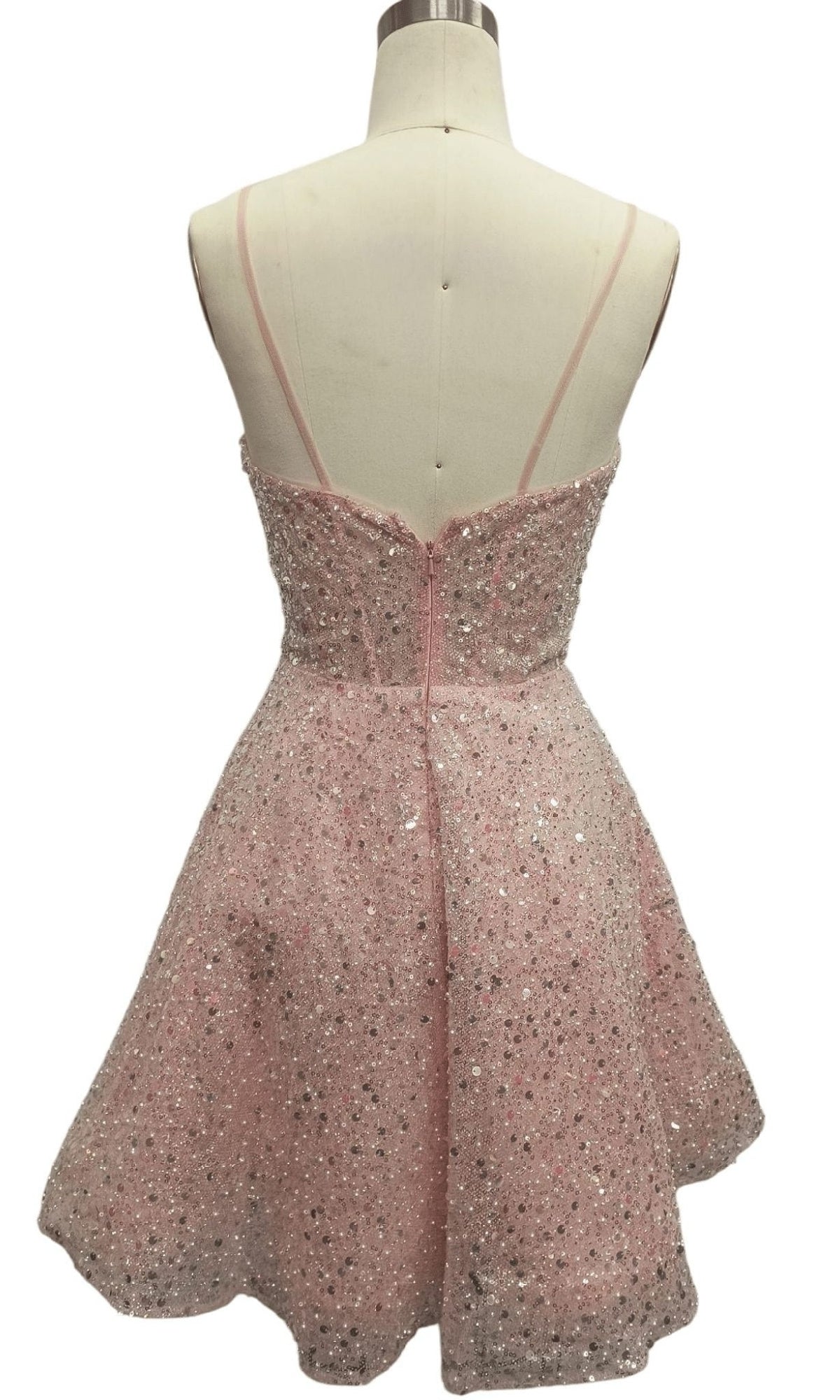 Back view of Short Pink Sequin Hoco Dress: 12461 with thin straps and silver sequin accents, displayed on a dress form.