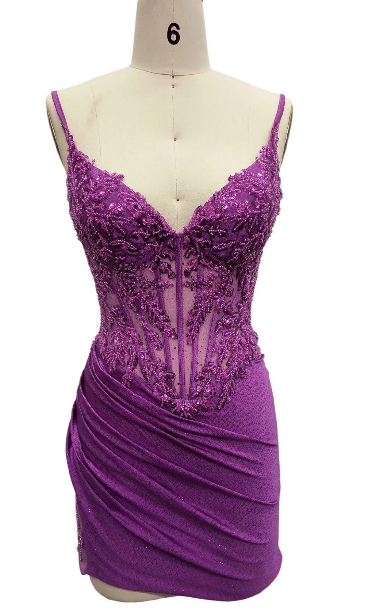 Bead-Corset Short Hoco Dress: 12515—a purple sleeveless mini dress on a mannequin with a corset-style bodice, sheer floral embroidery, and draped ruched skirt; the ideal bodycon homecoming party dress.