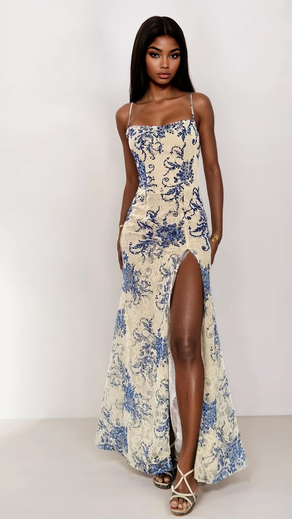 Woman wearing a floral dress with a high slit on a white background