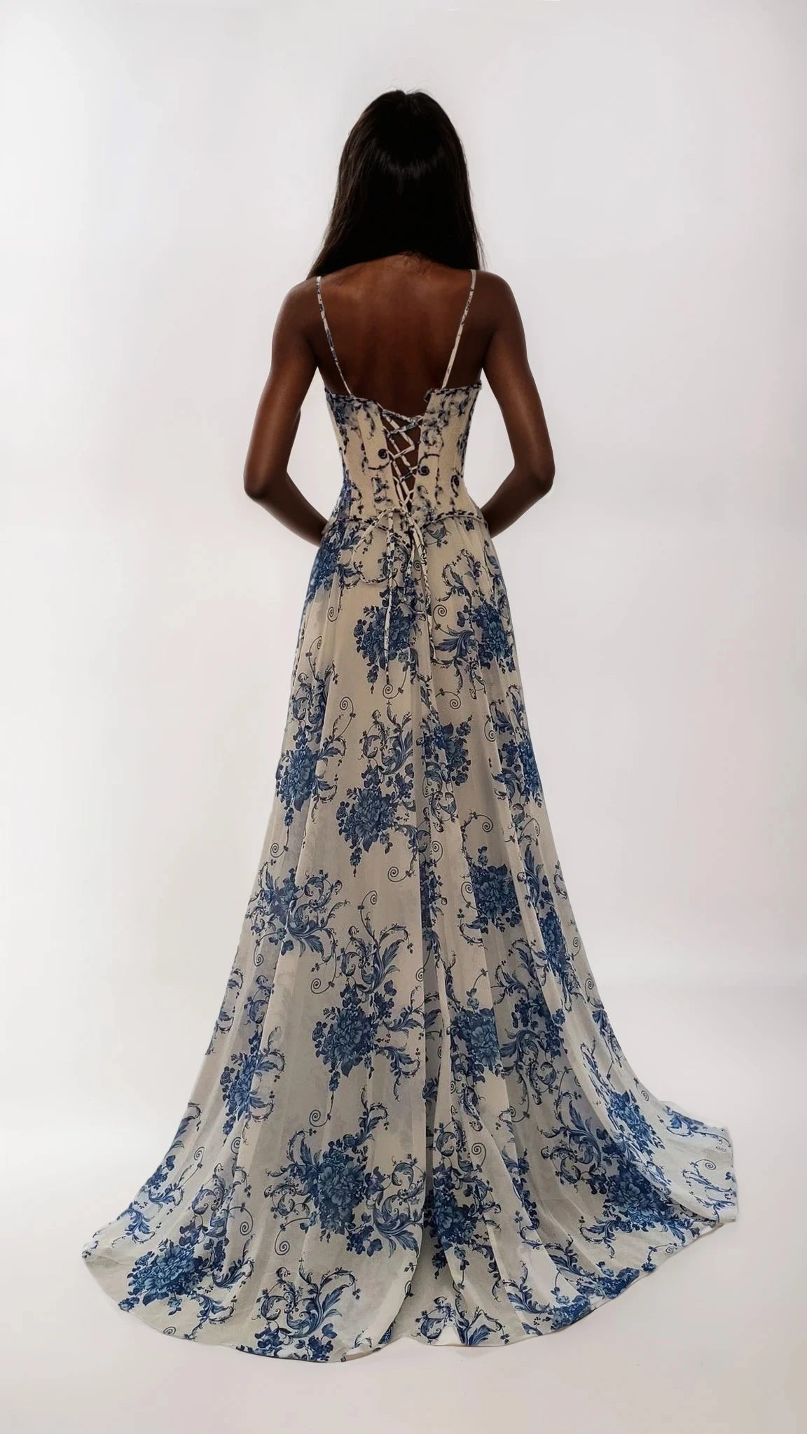 Woman wearing a blue floral dress on a white background