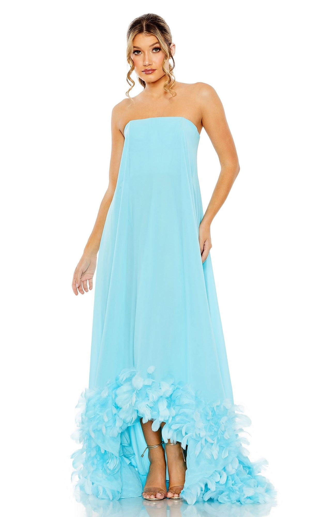 Woman models the Mac Duggal 13001 Strapless Trapeze Formal Gown in light blue, featuring feather-trimmed hem—an elegant choice for prom or evening events, set against a white background.