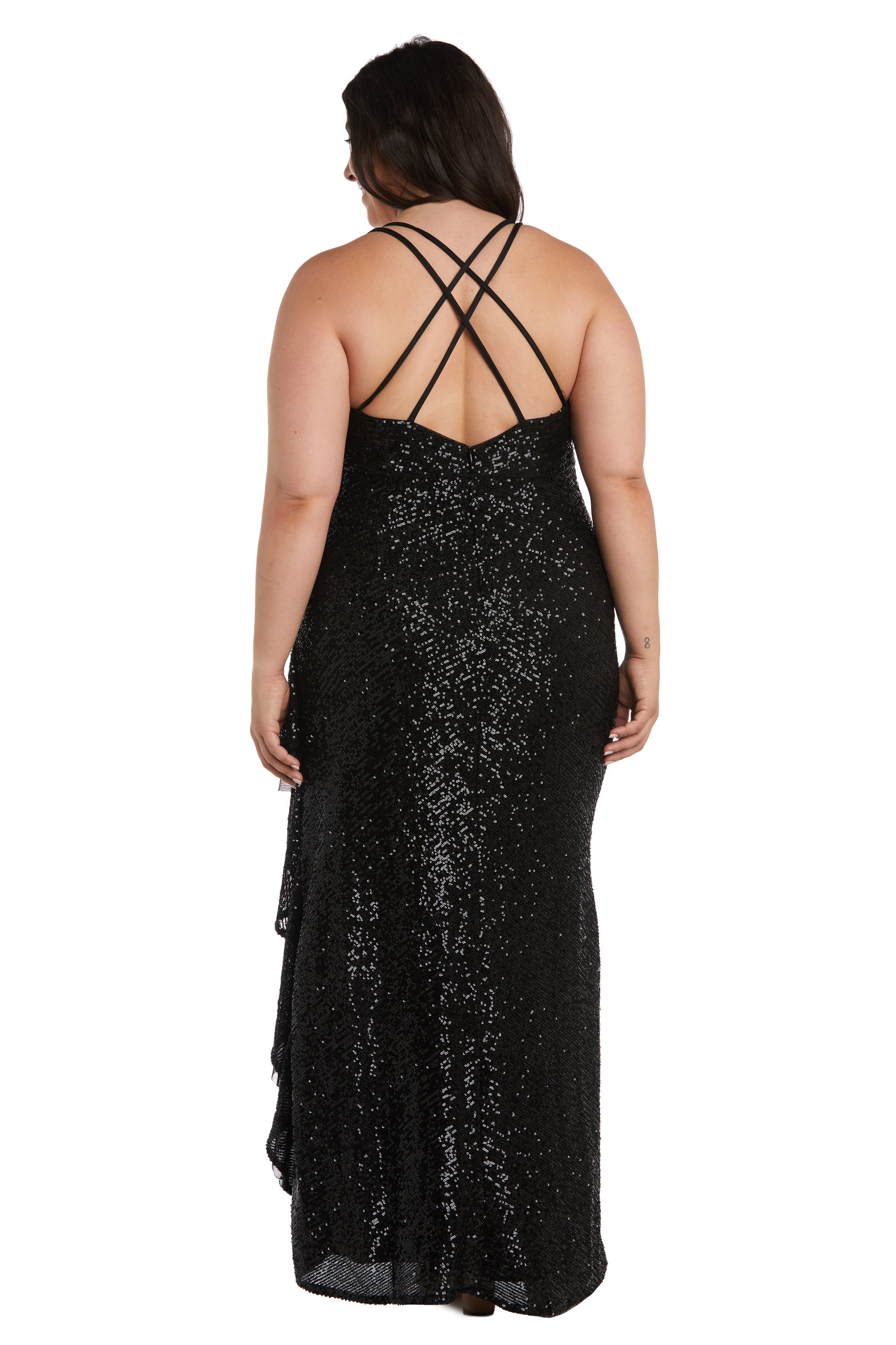 A woman wearing the Long Plus-Size Sequin Prom Dress: Morgan 13029WM, featuring a black floor-length design with crisscross straps and an empire waistline, stands facing away from the camera.
