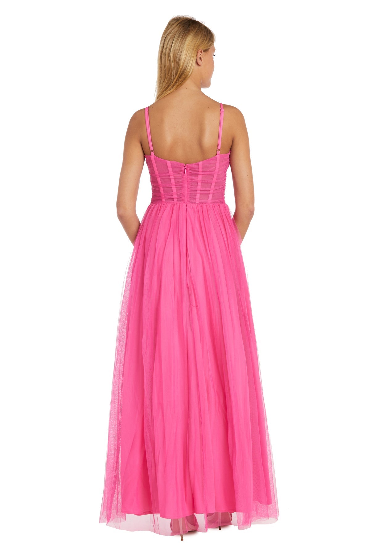 A woman faces away, wearing the Hot Pink A-Line Corset Prom Dress: Morgan 13155, featuring a floor-length skirt and a corset bodice.