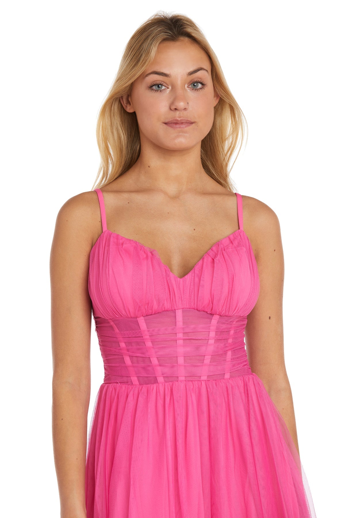 A woman with long blonde hair wears the Morgan 13155 Hot Pink A-Line Corset Prom Dress, featuring thin straps and a fitted, ruched bodice, standing against a plain white background.