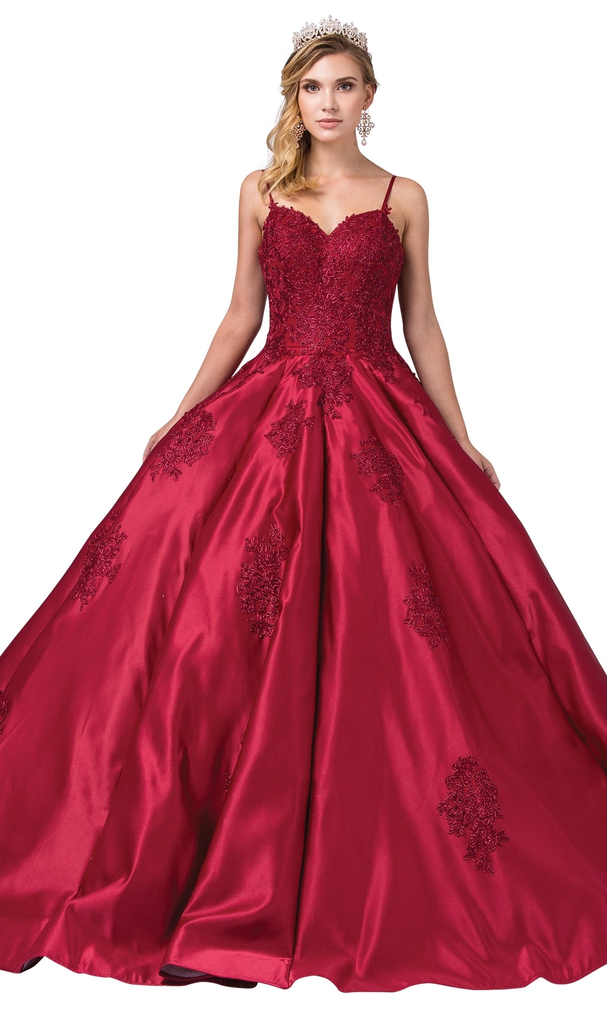 A woman wearing the Quinceanera Dress 1325 by Dancing Queen, a deep red A-line ball gown with lace applique detailing and a tiara, stands against a white background.