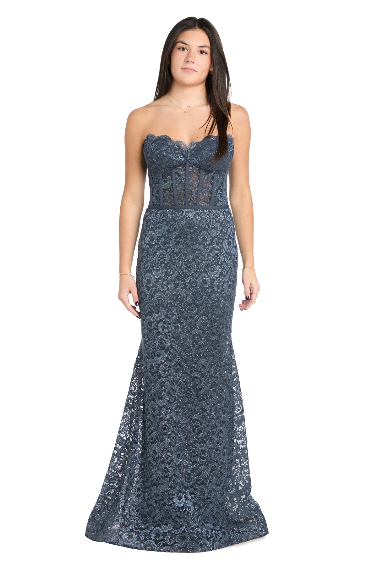 A woman faces forward wearing the Strapless Long Lace Prom Dress: Morgan 13269 in dark blue, featuring a sheer corset bodice and elegant floor-length mermaid design.